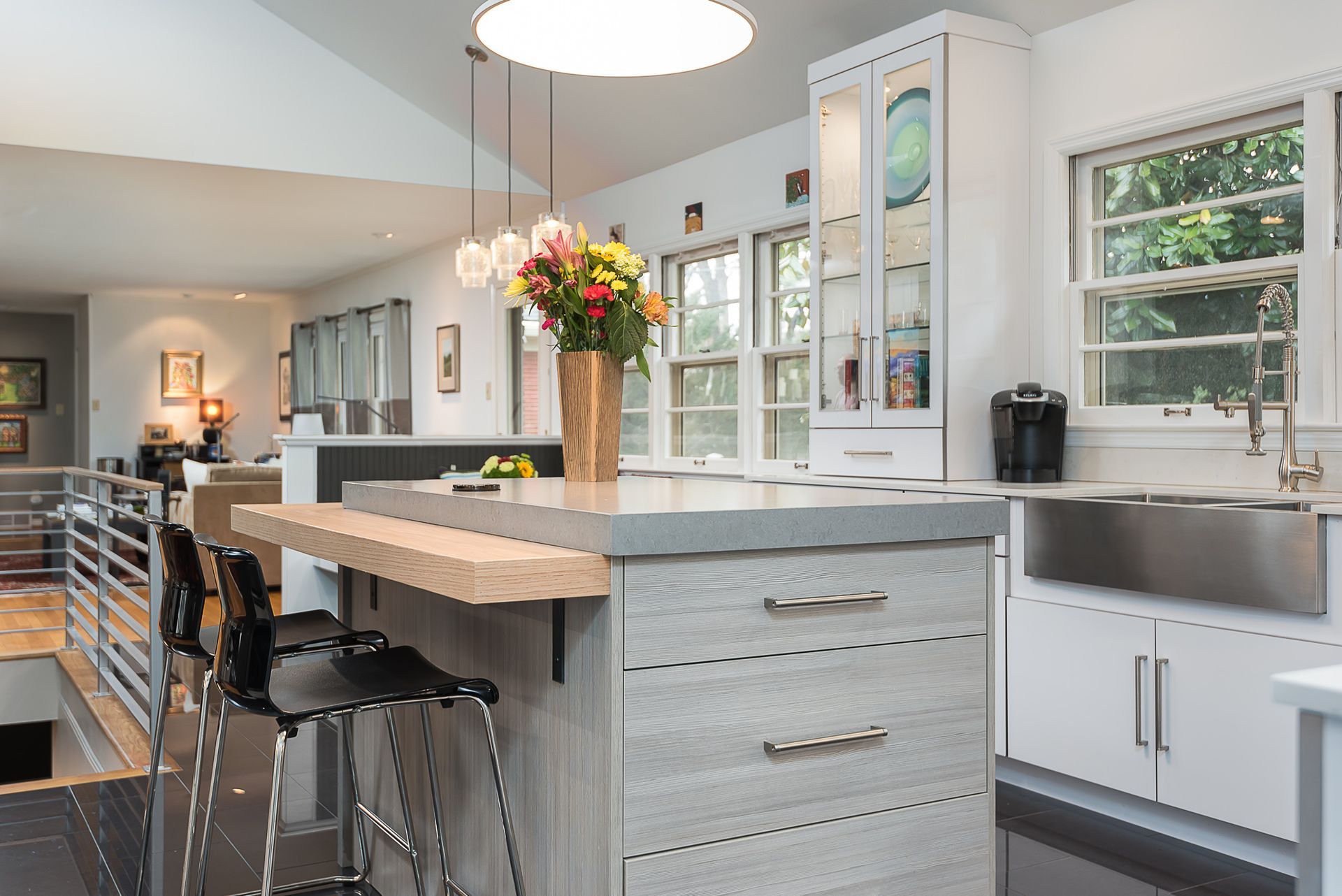 A kitchen with a large island and a stainless steel sink.
