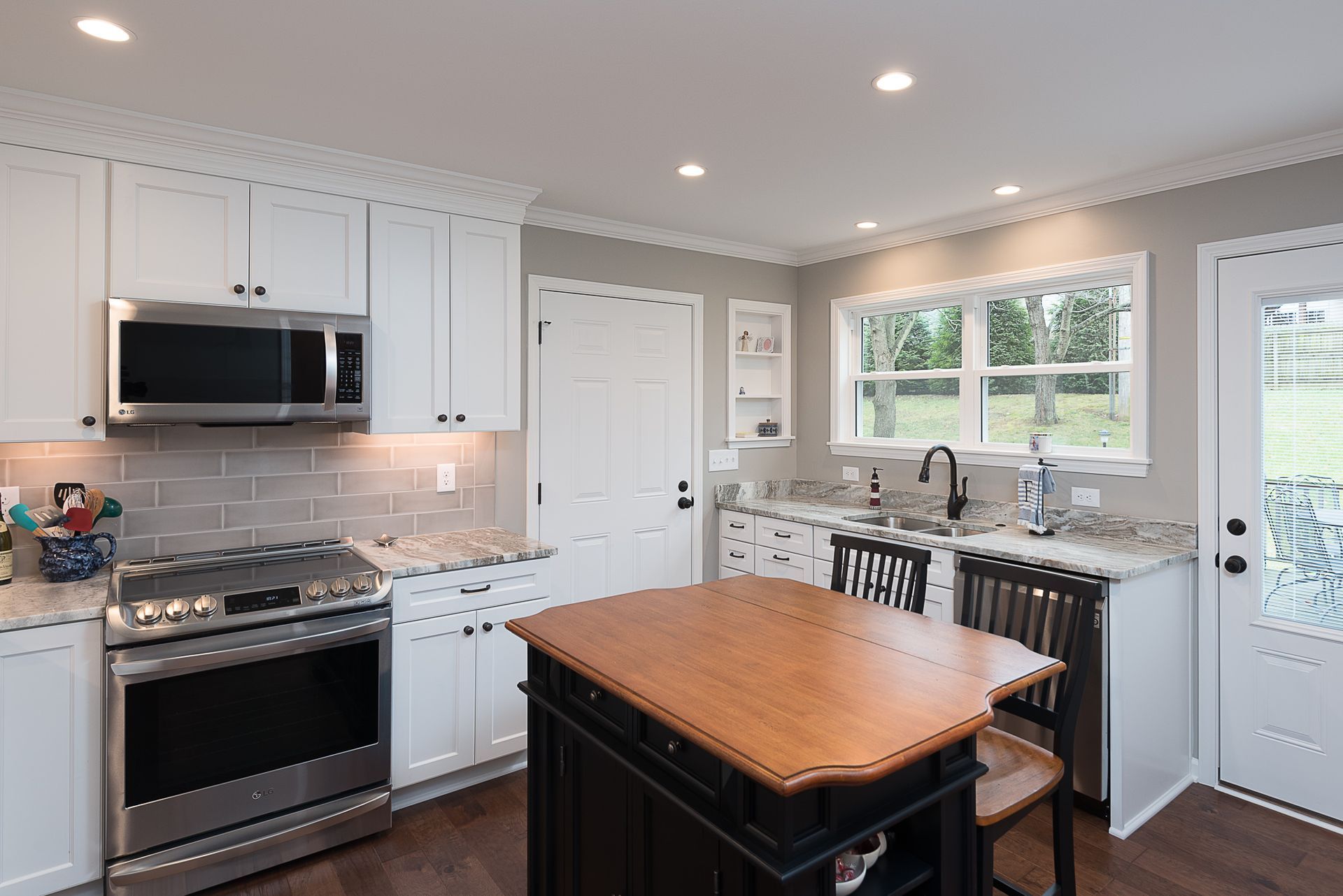 Remodeled kitchen with stainless steel appliances and wooden island.