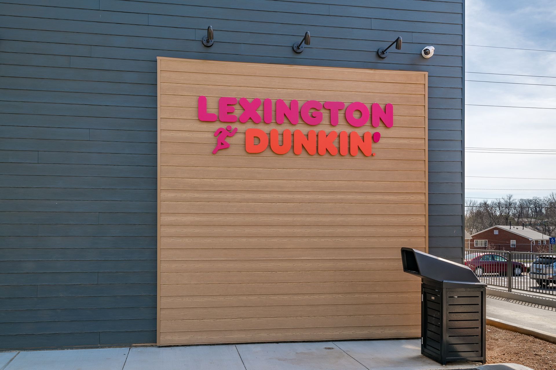 A lexington dunkin ' sign on the side of a building
