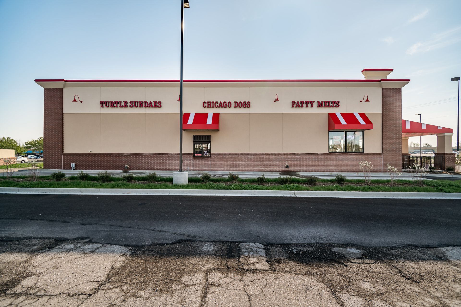 A large building with a red awning on the side of it.