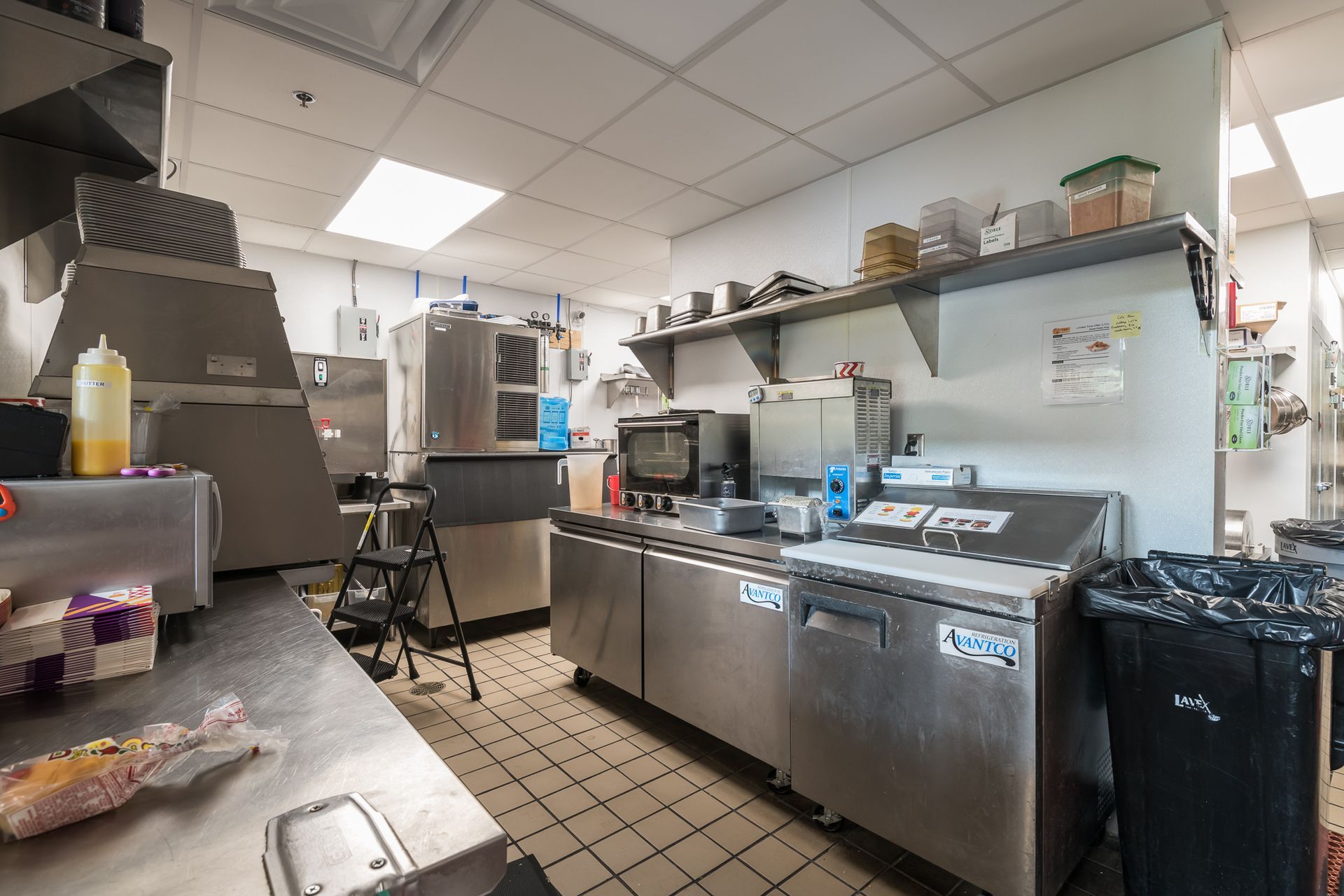 A kitchen with a lot of stainless steel appliances and a stove.