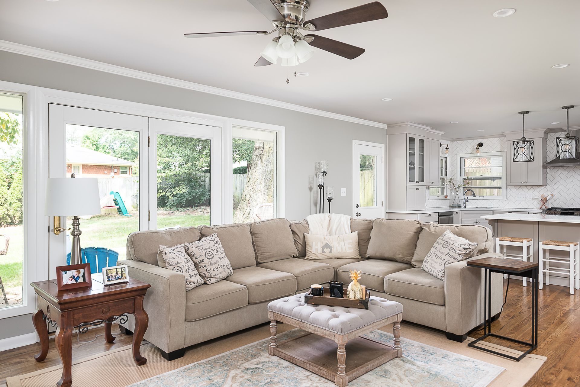 A living room with a couch , coffee table , and ceiling fan.