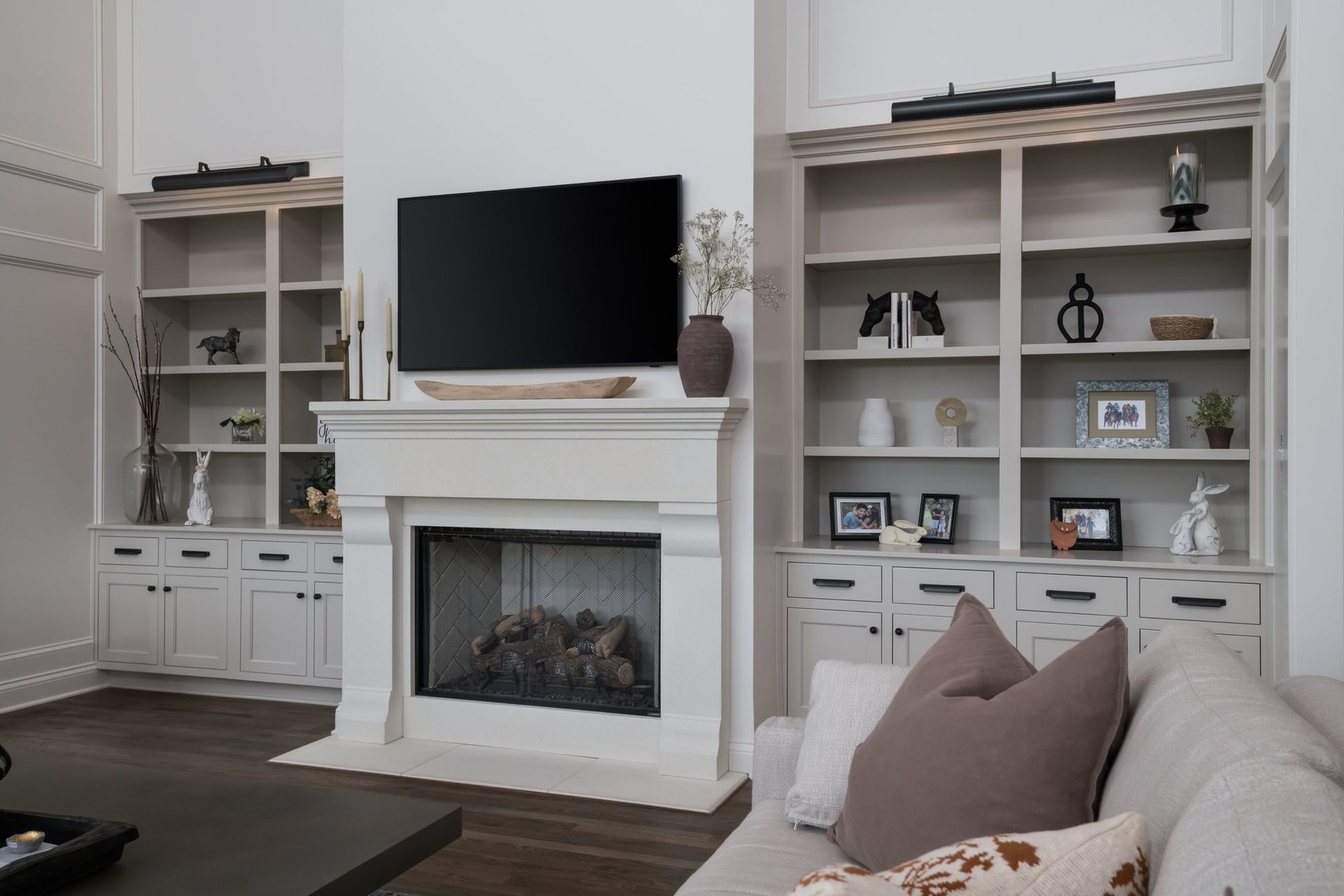 A living room with a fireplace and a flat screen tv