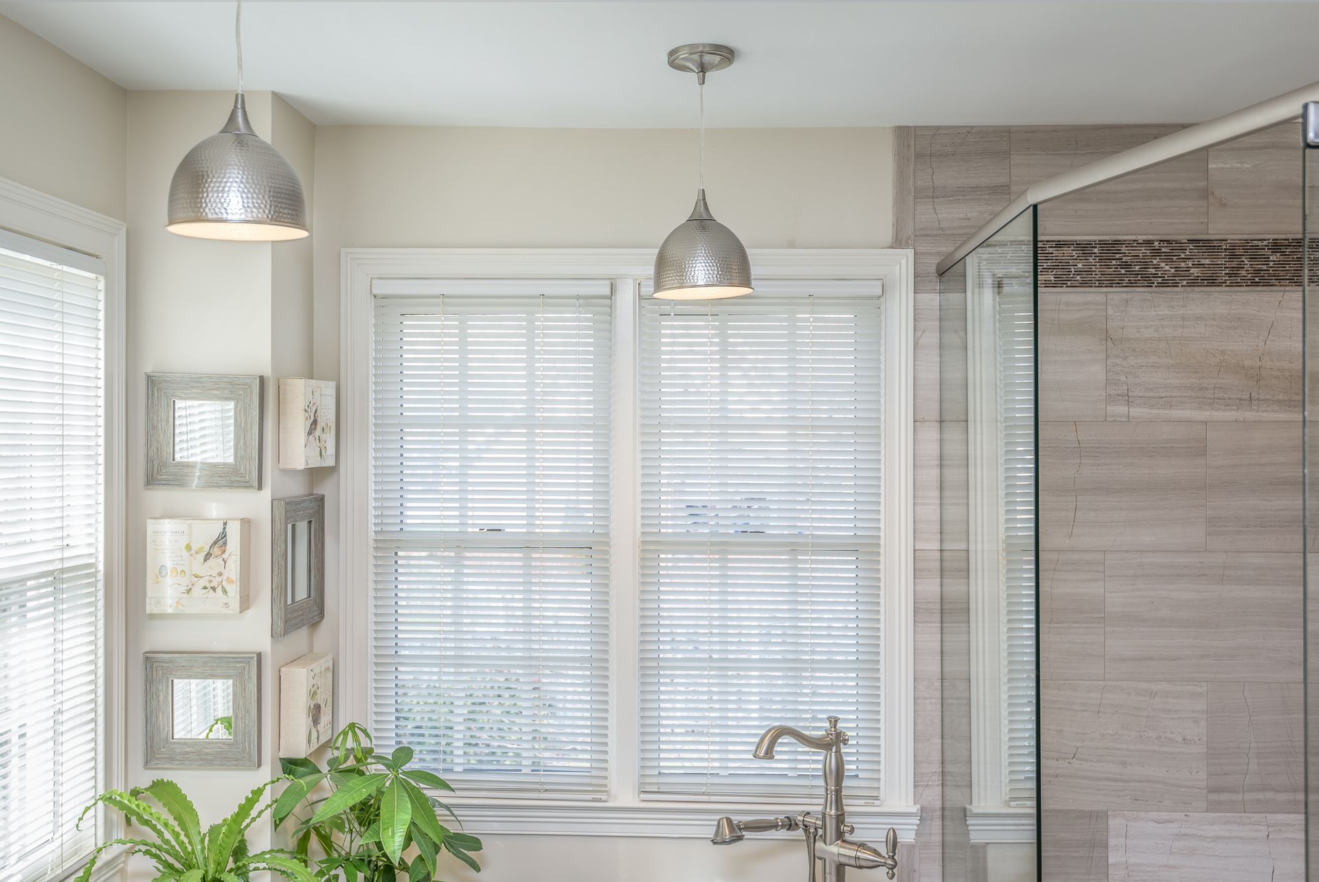 A bathroom with a sink and a window with blinds.