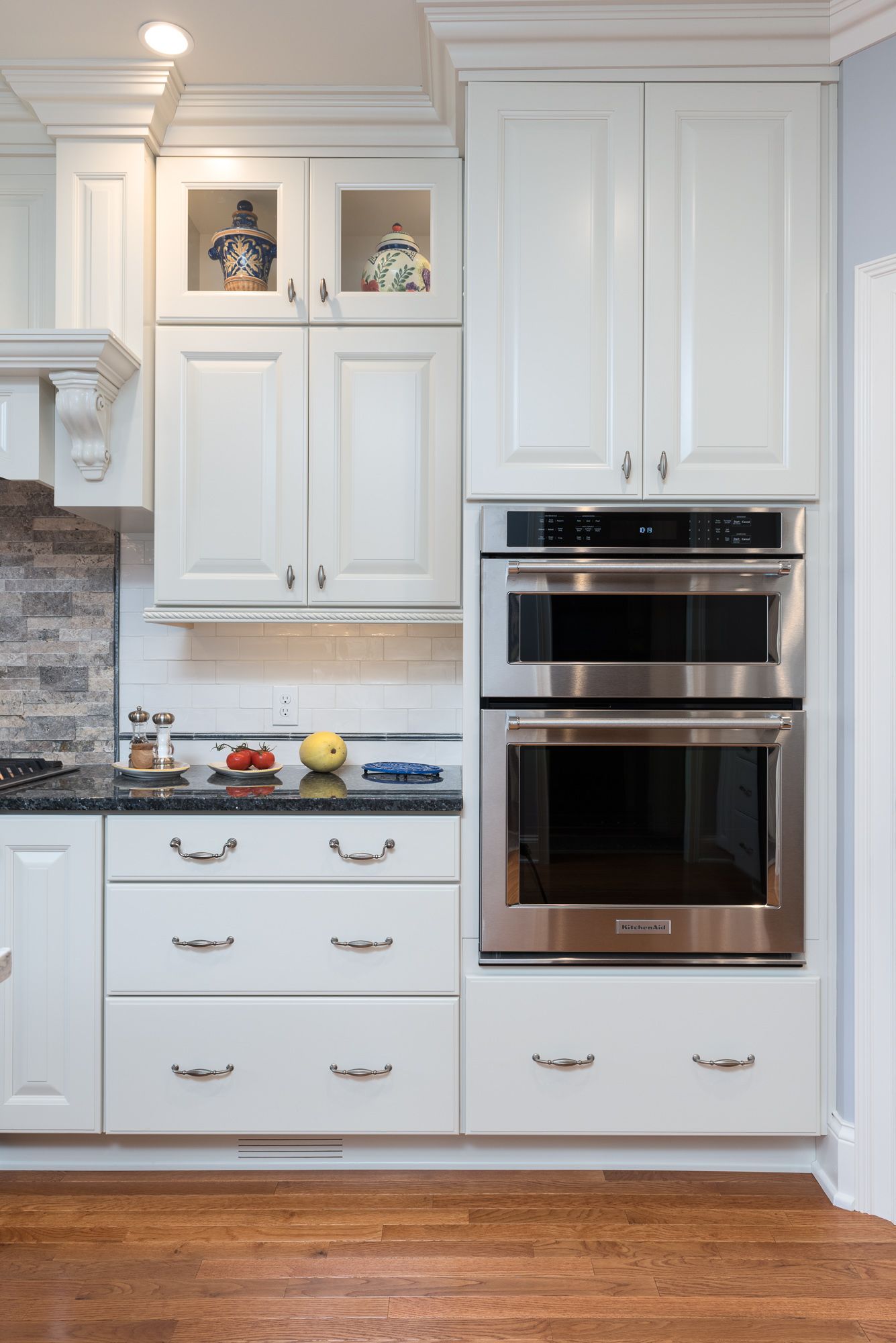 A kitchen with white cabinets and stainless steel appliances