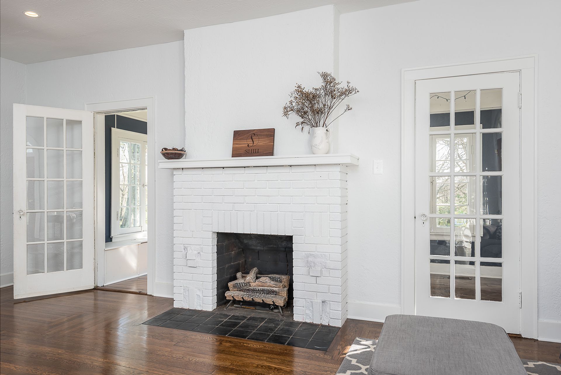 A living room with a fireplace and french doors