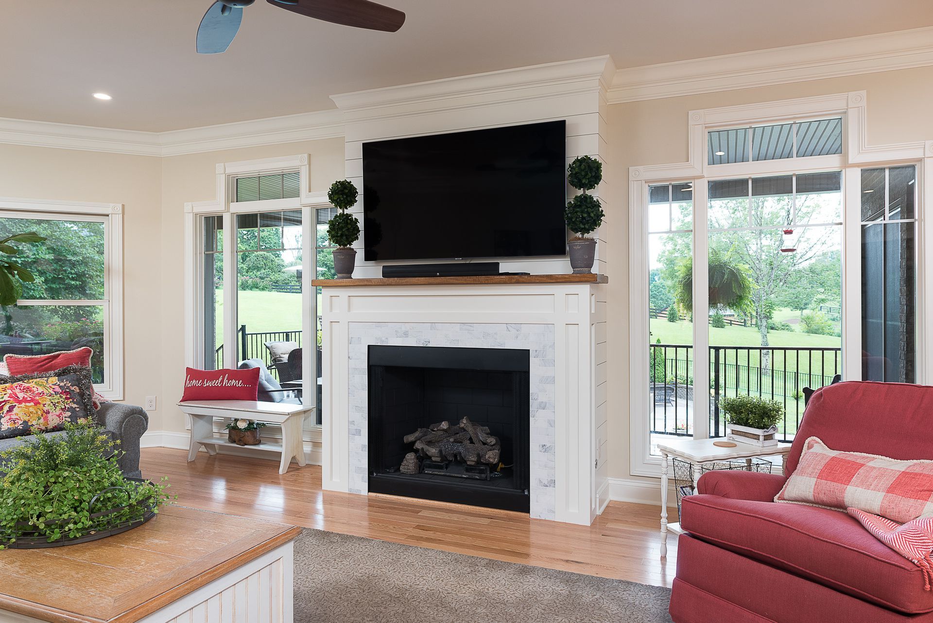 A living room with a fireplace and a flat screen tv.
