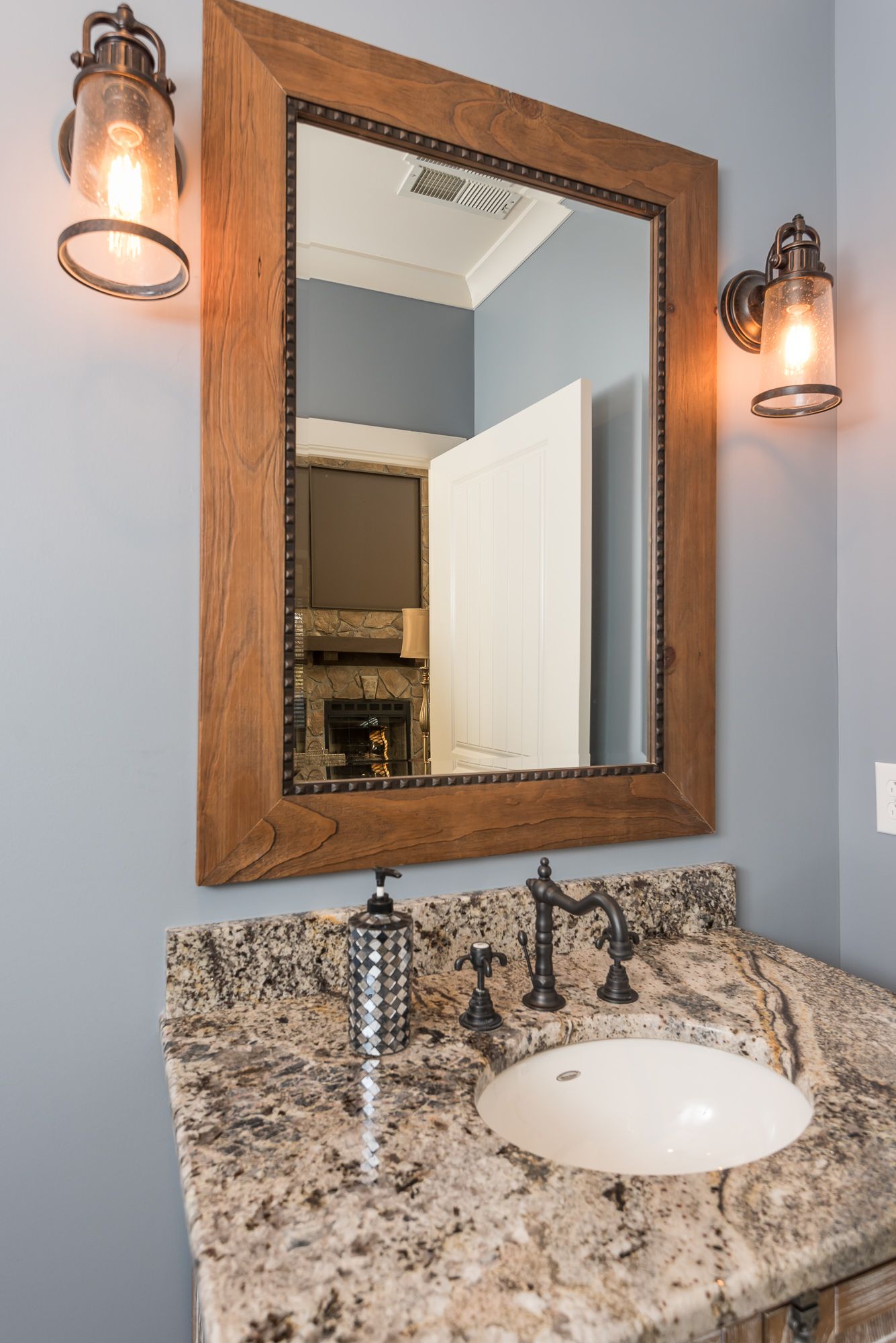 A bathroom with a sink and a mirror on the wall.