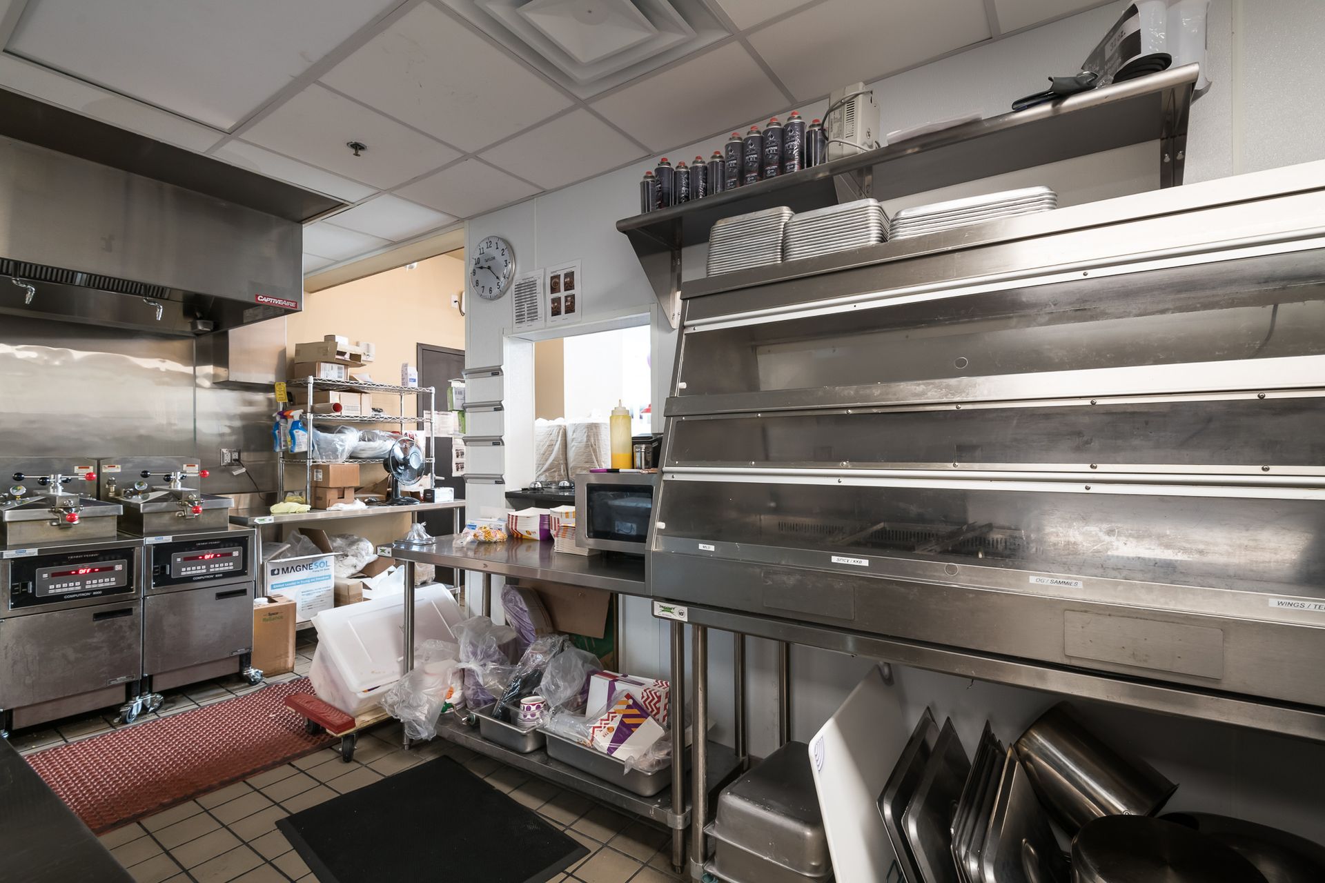 A kitchen with a lot of stainless steel appliances and utensils