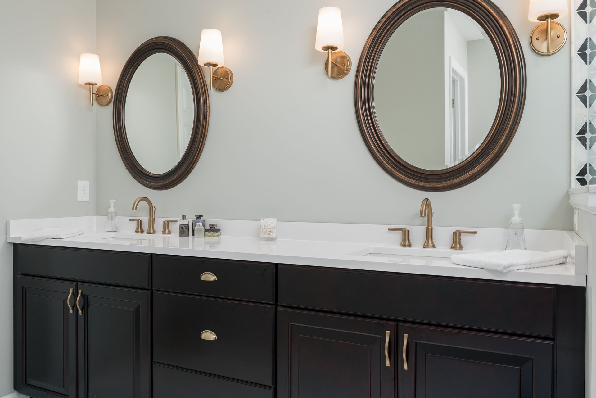 A bathroom with two sinks and two mirrors.