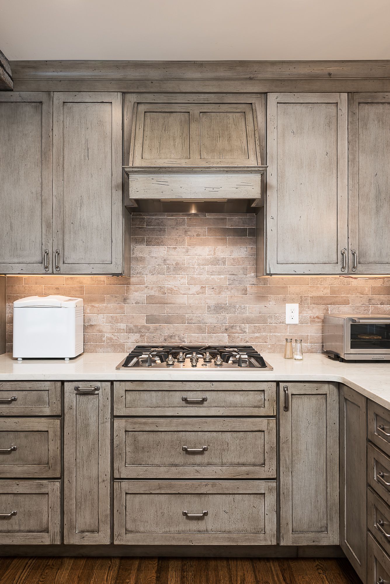 A kitchen with wooden cabinets and a stove top oven.