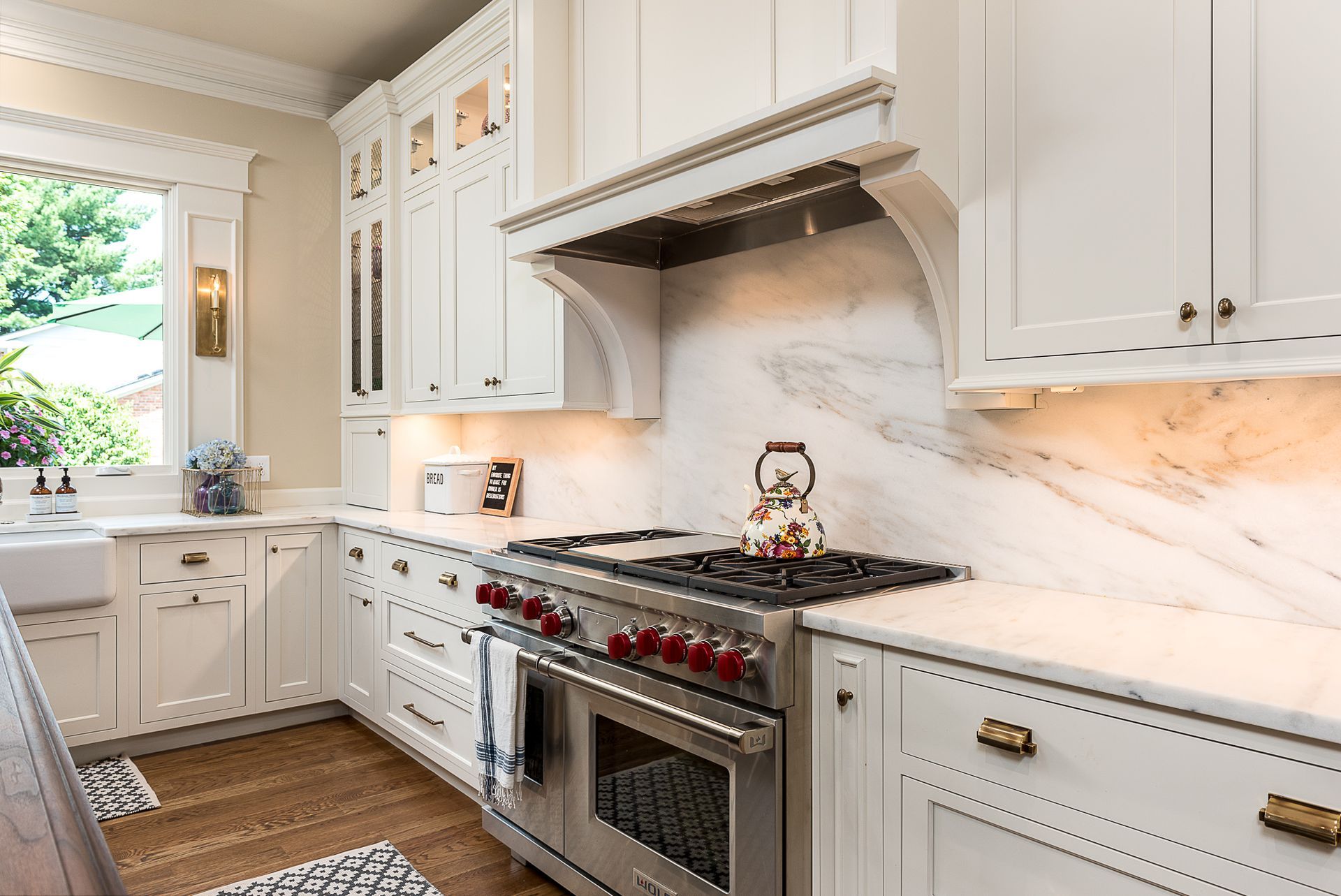 A kitchen with white cabinets and stainless steel appliances.