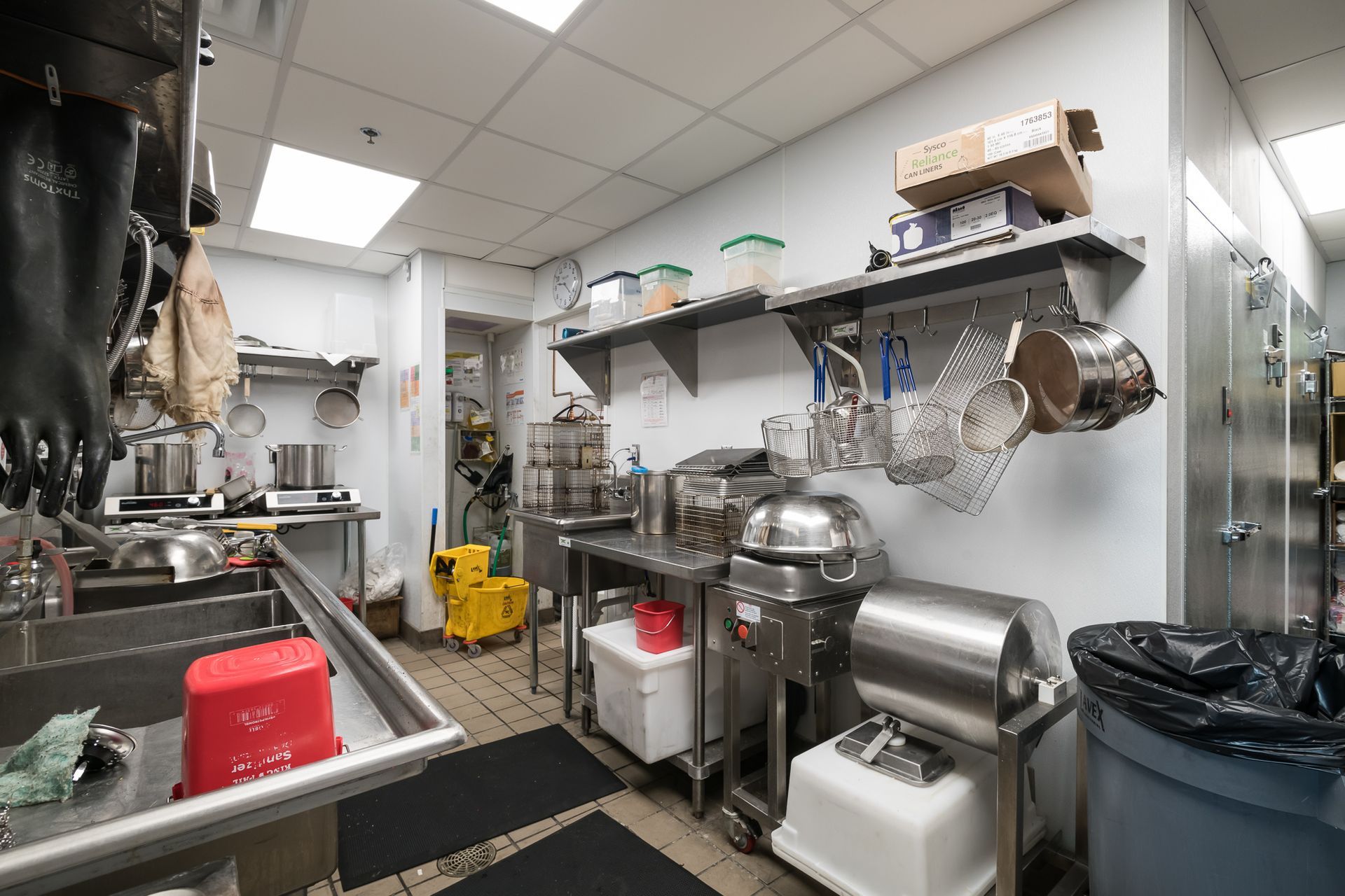 A kitchen with a lot of stainless steel appliances and a sink.