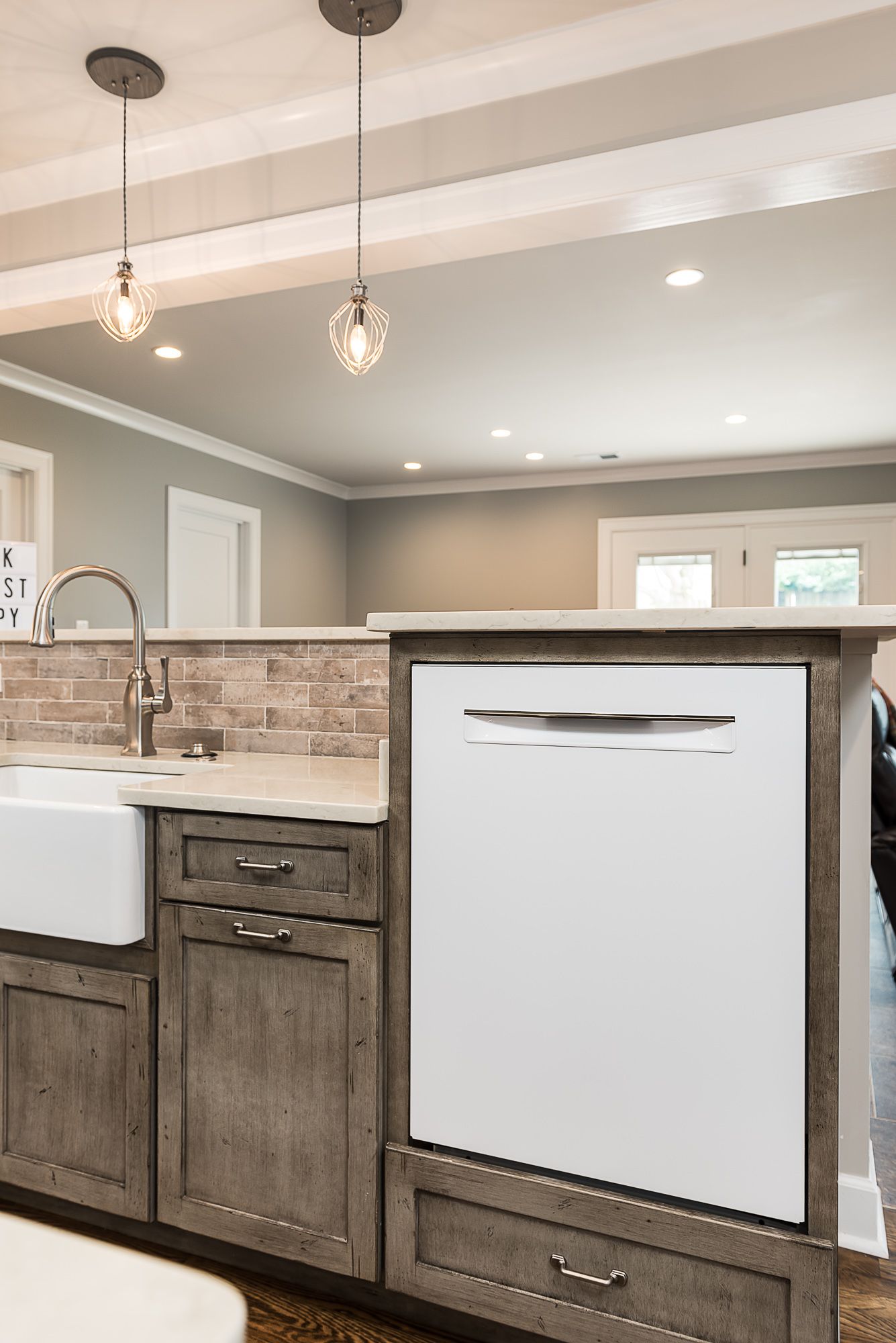 A kitchen with a white dishwasher and a sink.