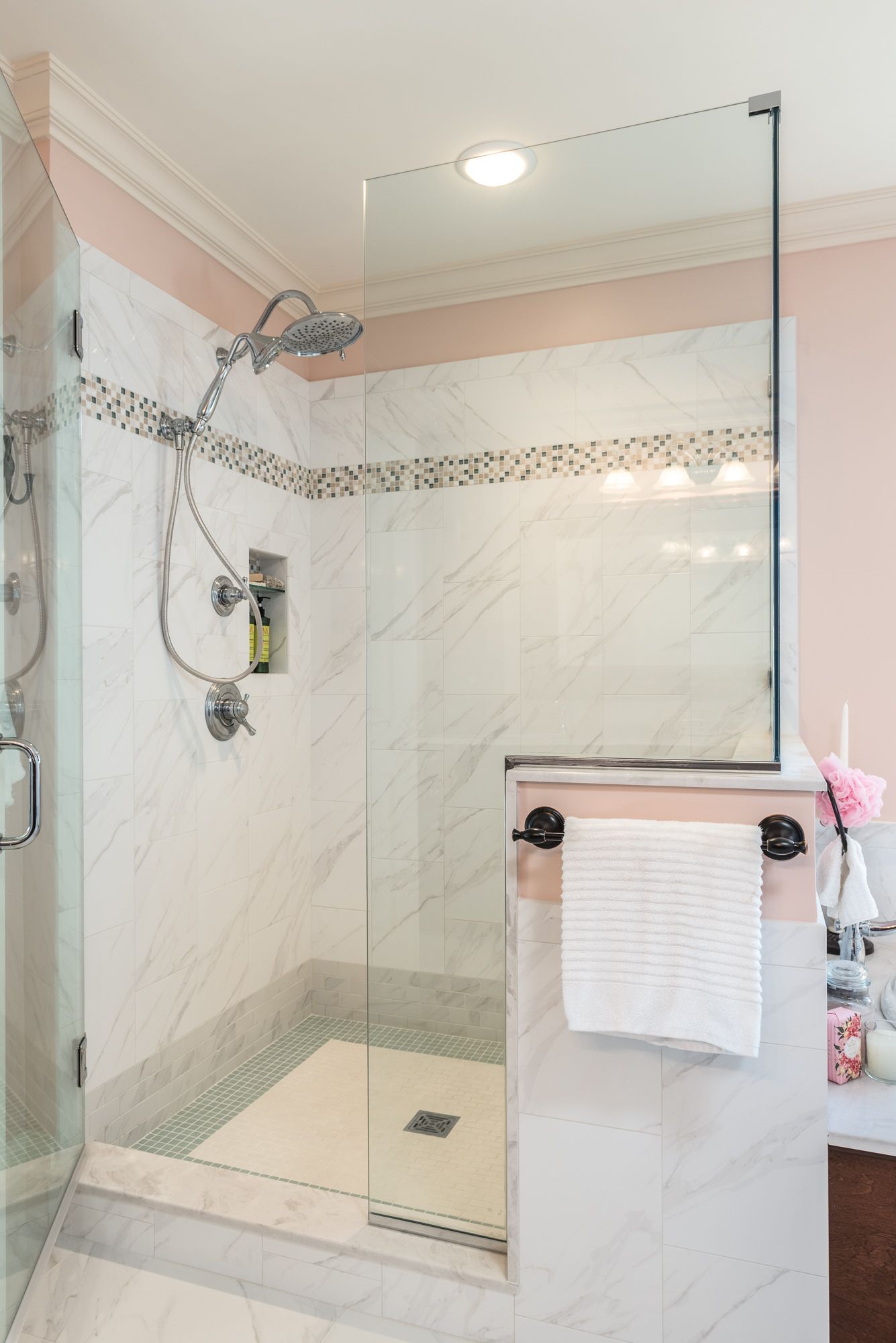 A bathroom with a walk in shower and a mirror.