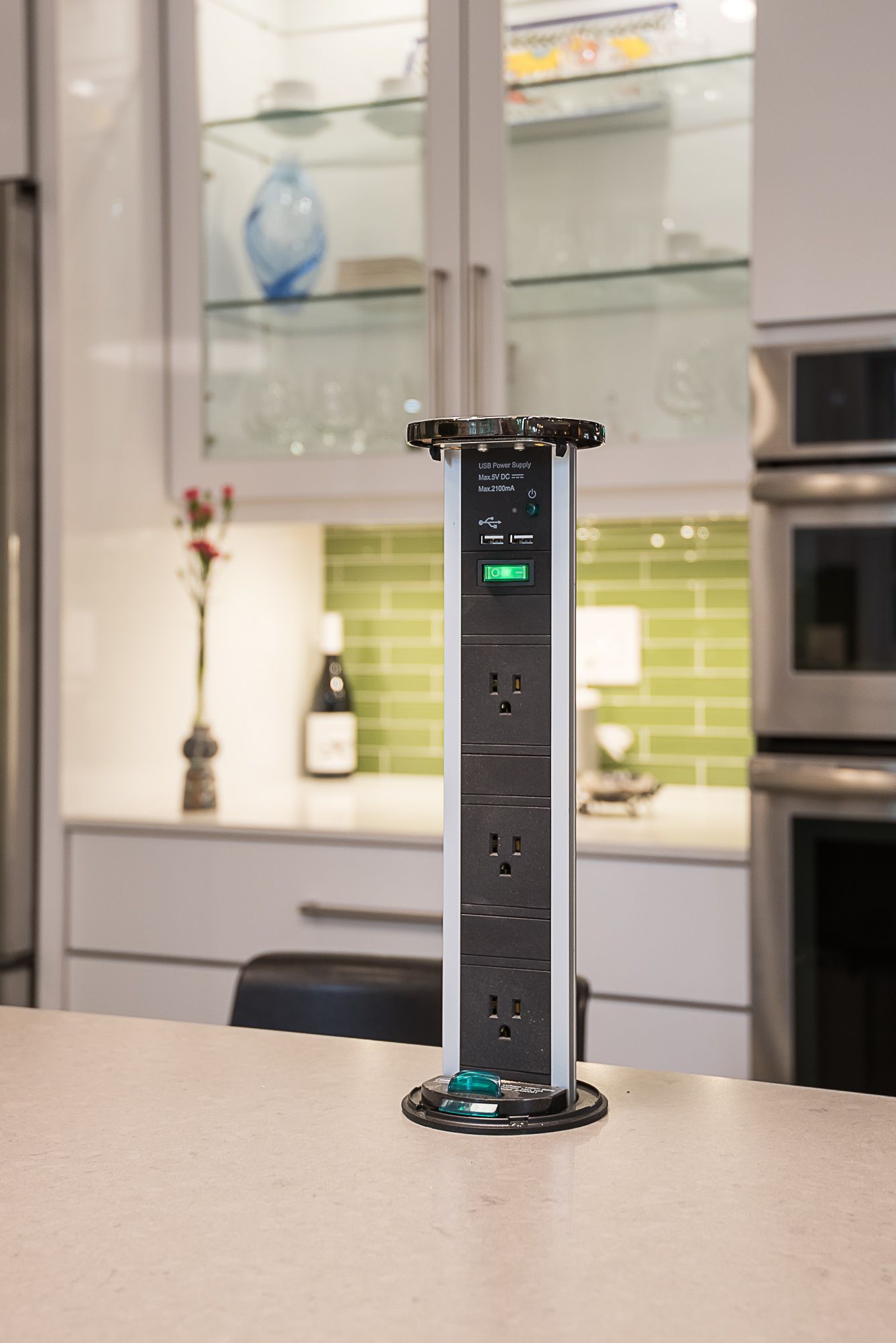 A power strip is sitting on top of a kitchen counter.