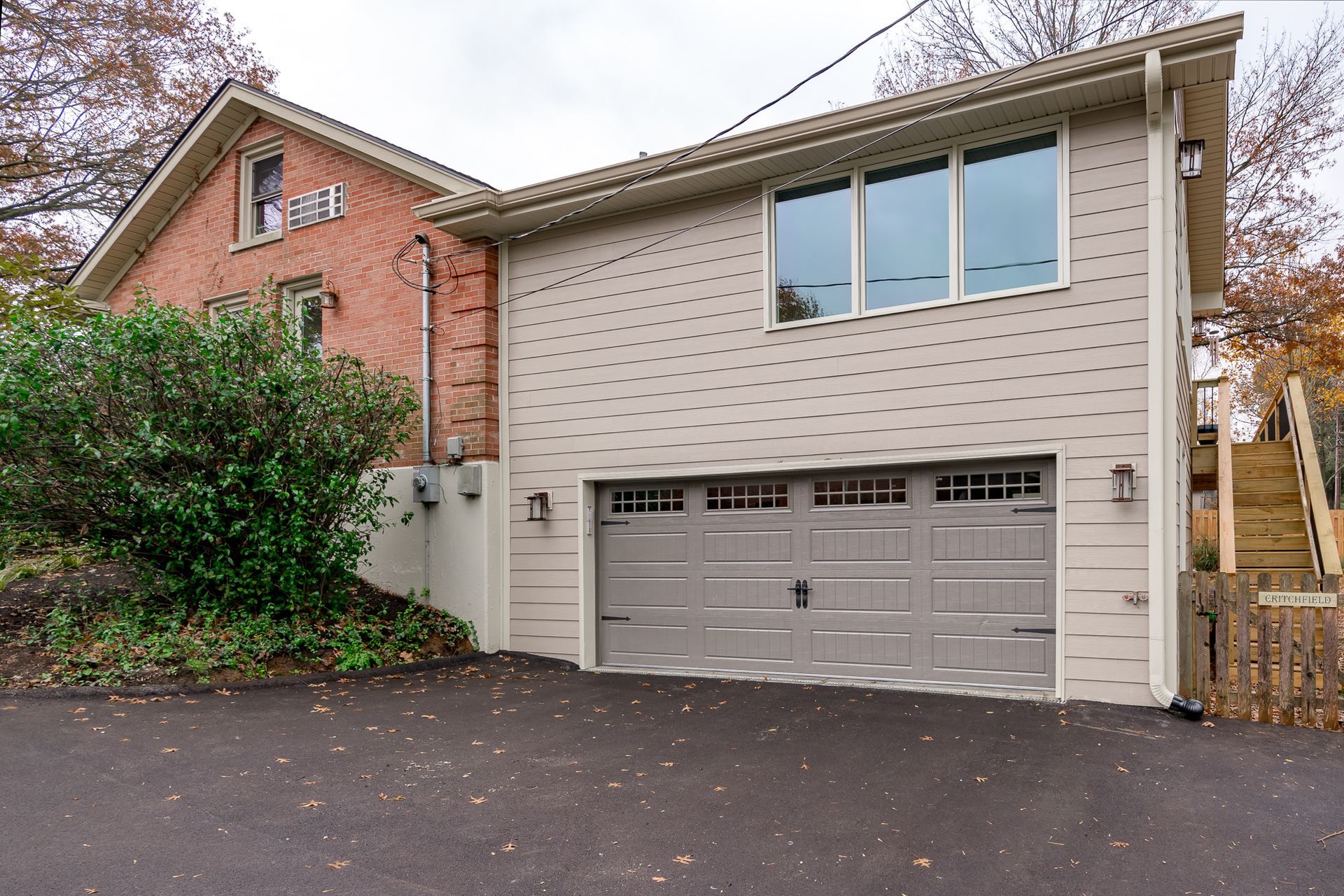 A house with a garage and stairs leading up to it