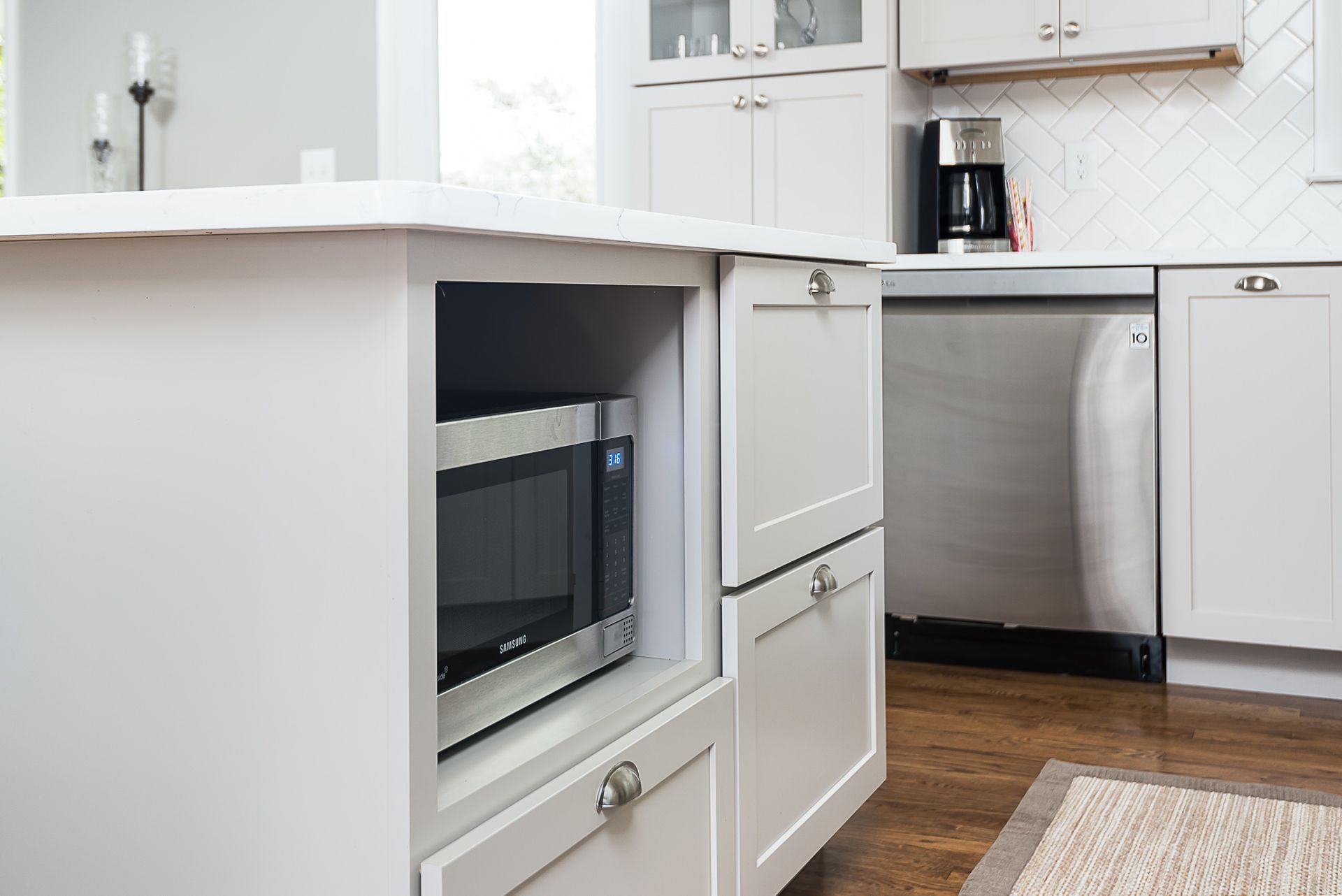 A kitchen with white cabinets and stainless steel appliances.