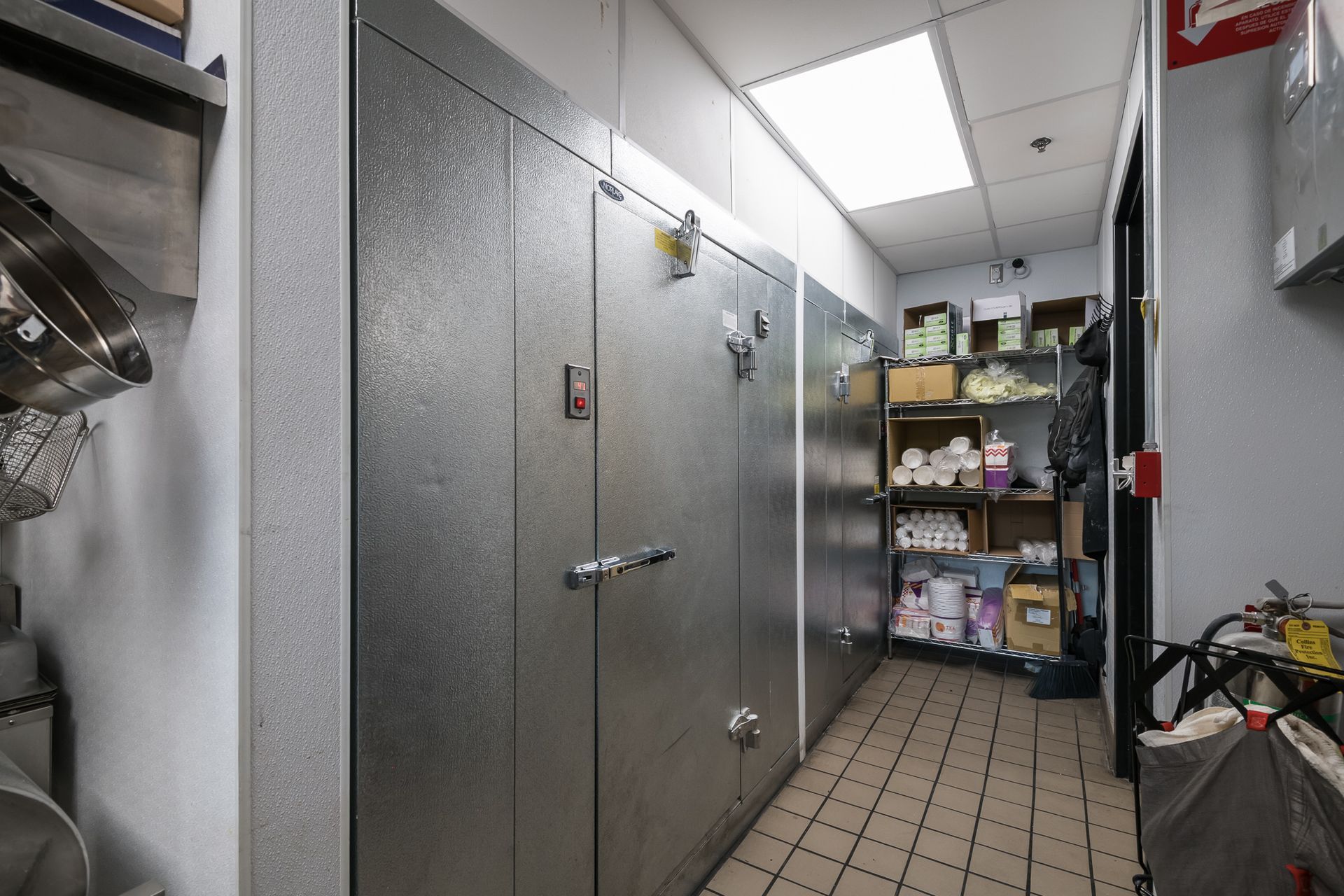 A kitchen with a lot of stainless steel cabinets and shelves