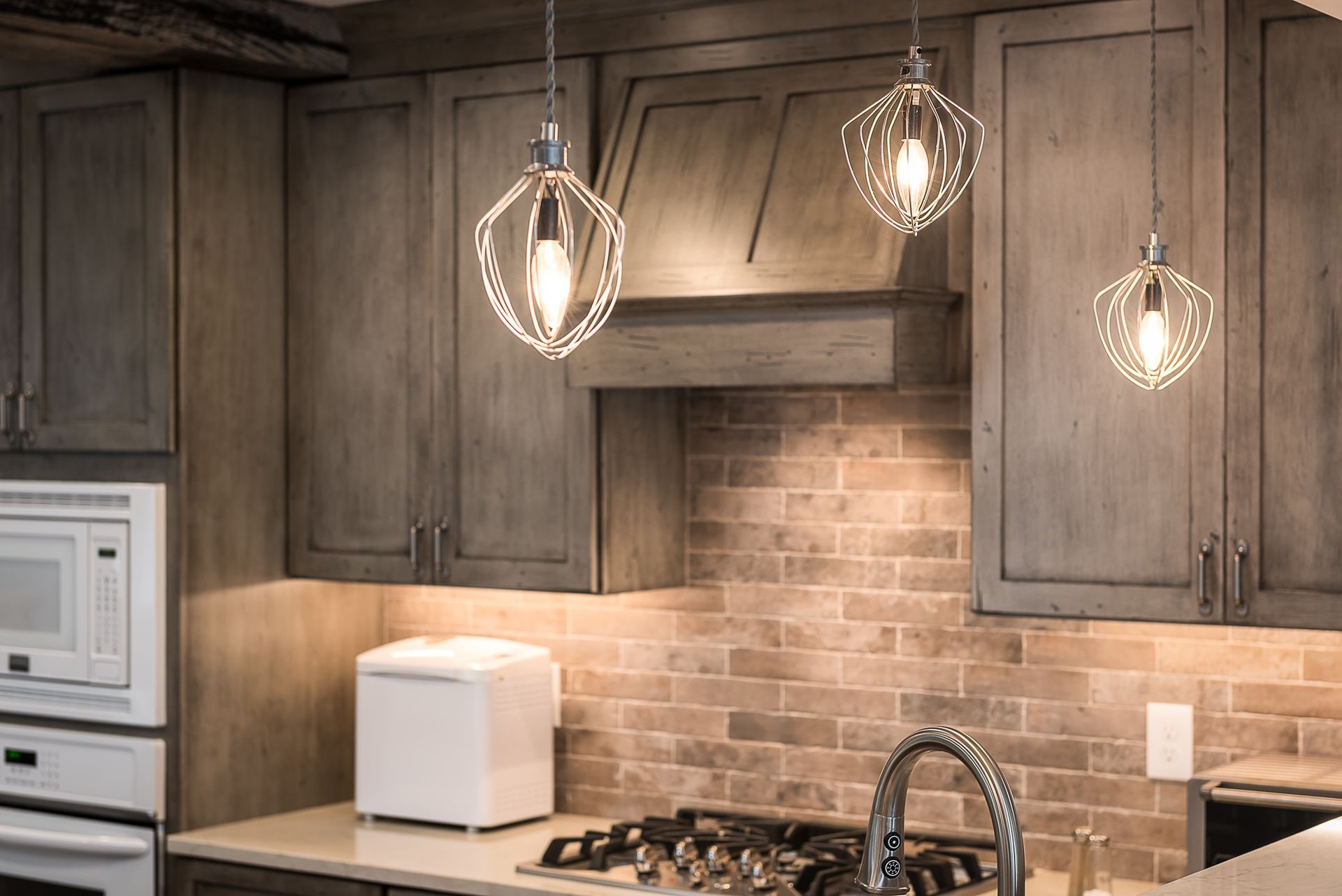 A bathroom with two sinks , two mirrors and a bench.
