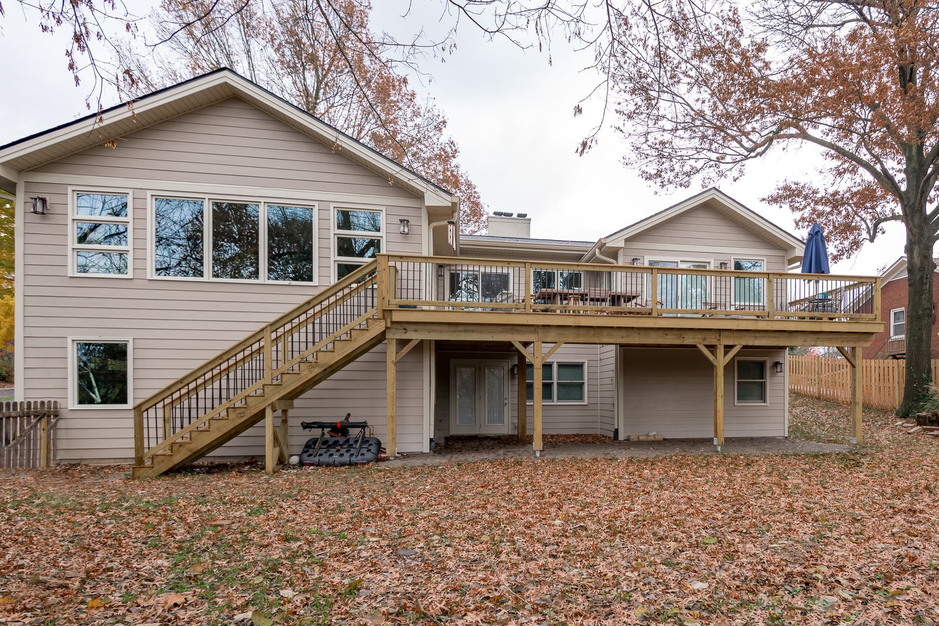The back of a house with a large deck and stairs