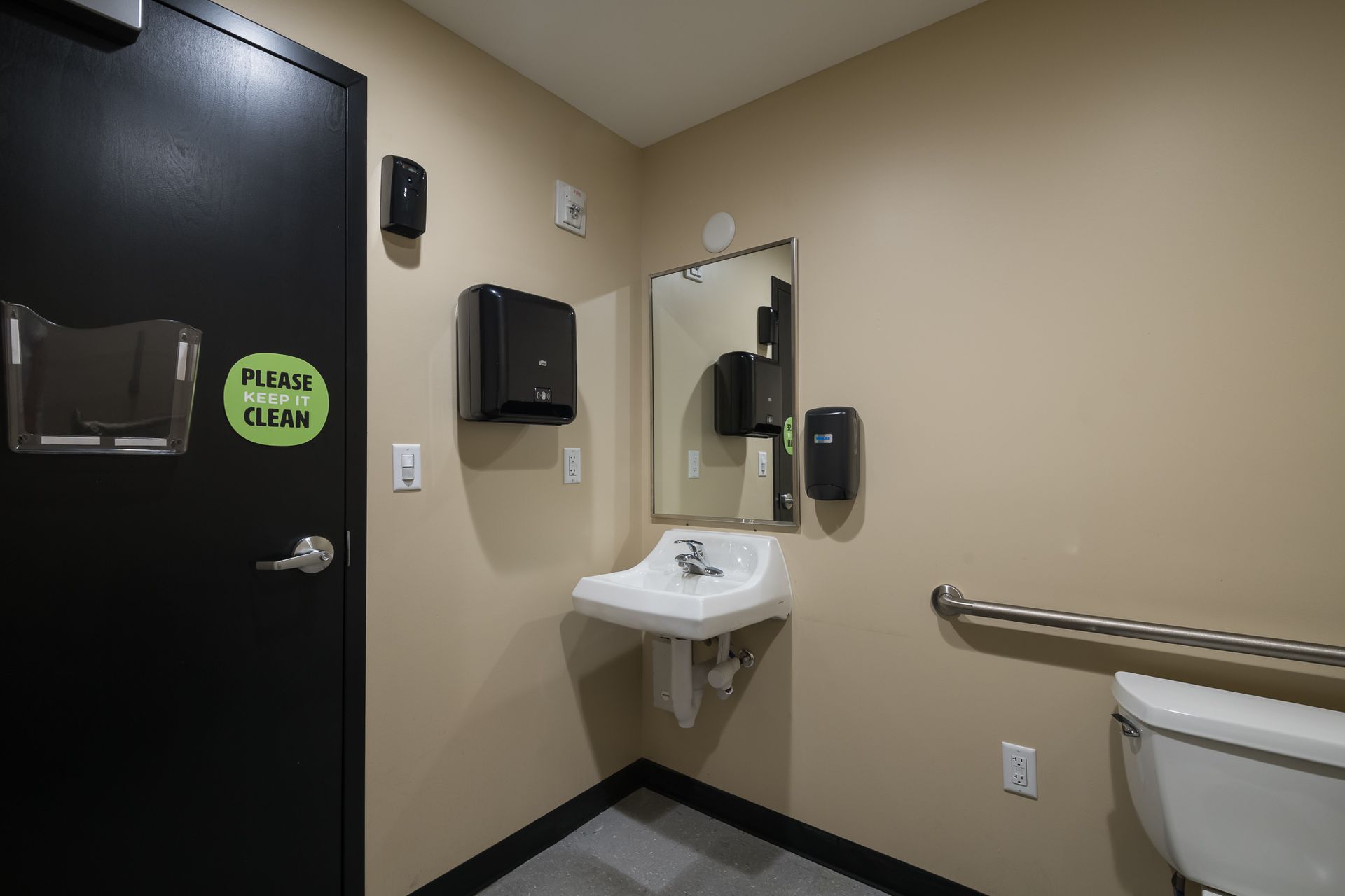 A bathroom with a sink , toilet and mirror.