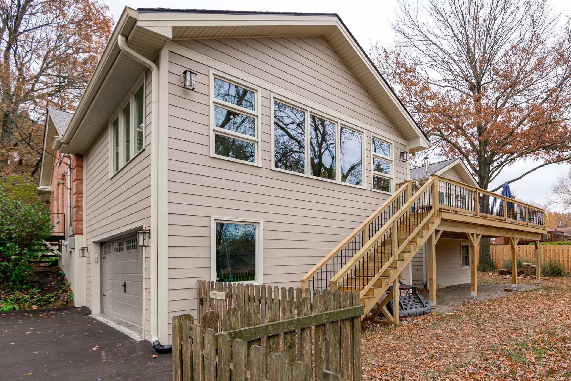 A house with a garage and stairs leading up to it.