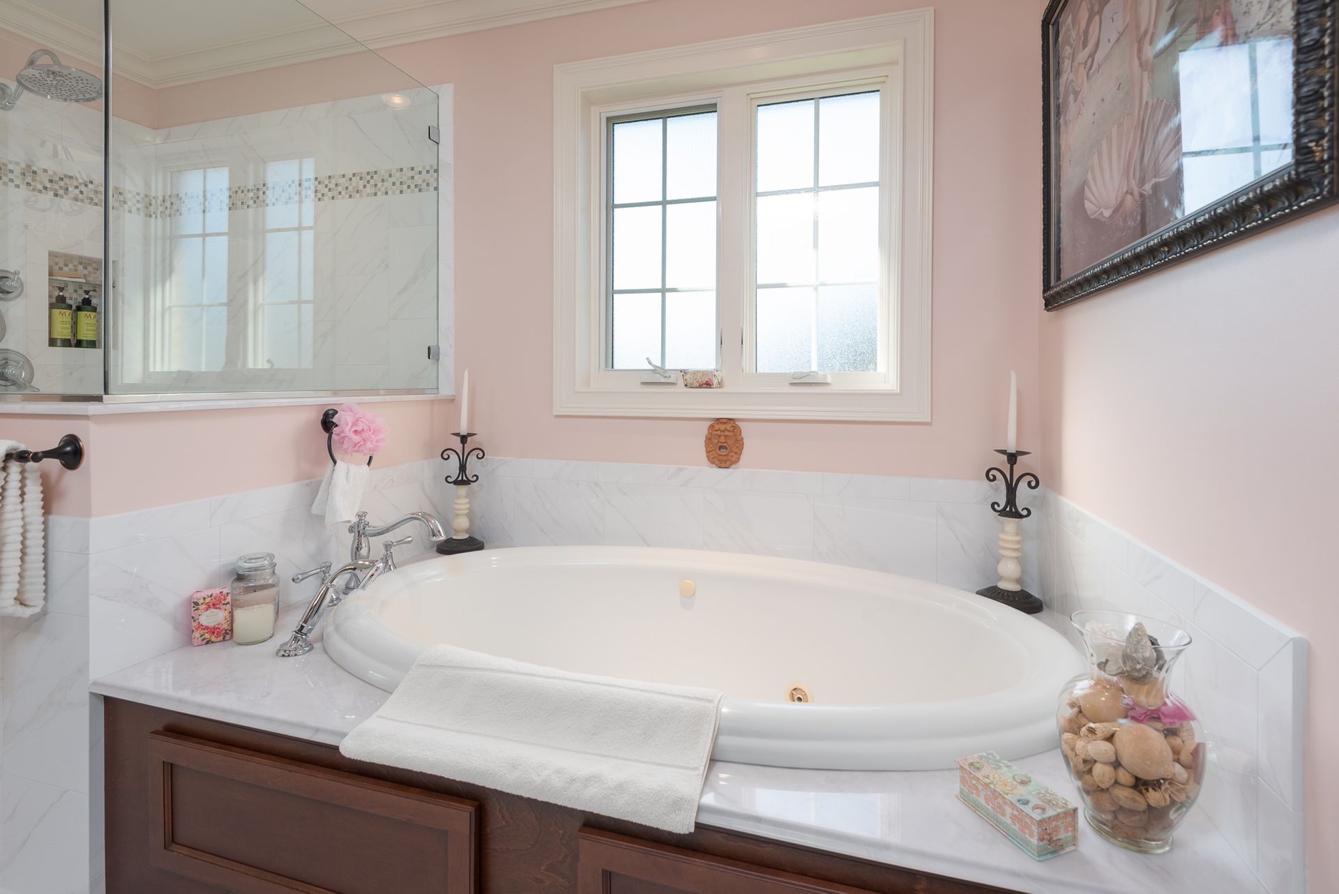 A bathroom with a jacuzzi tub and a window.
