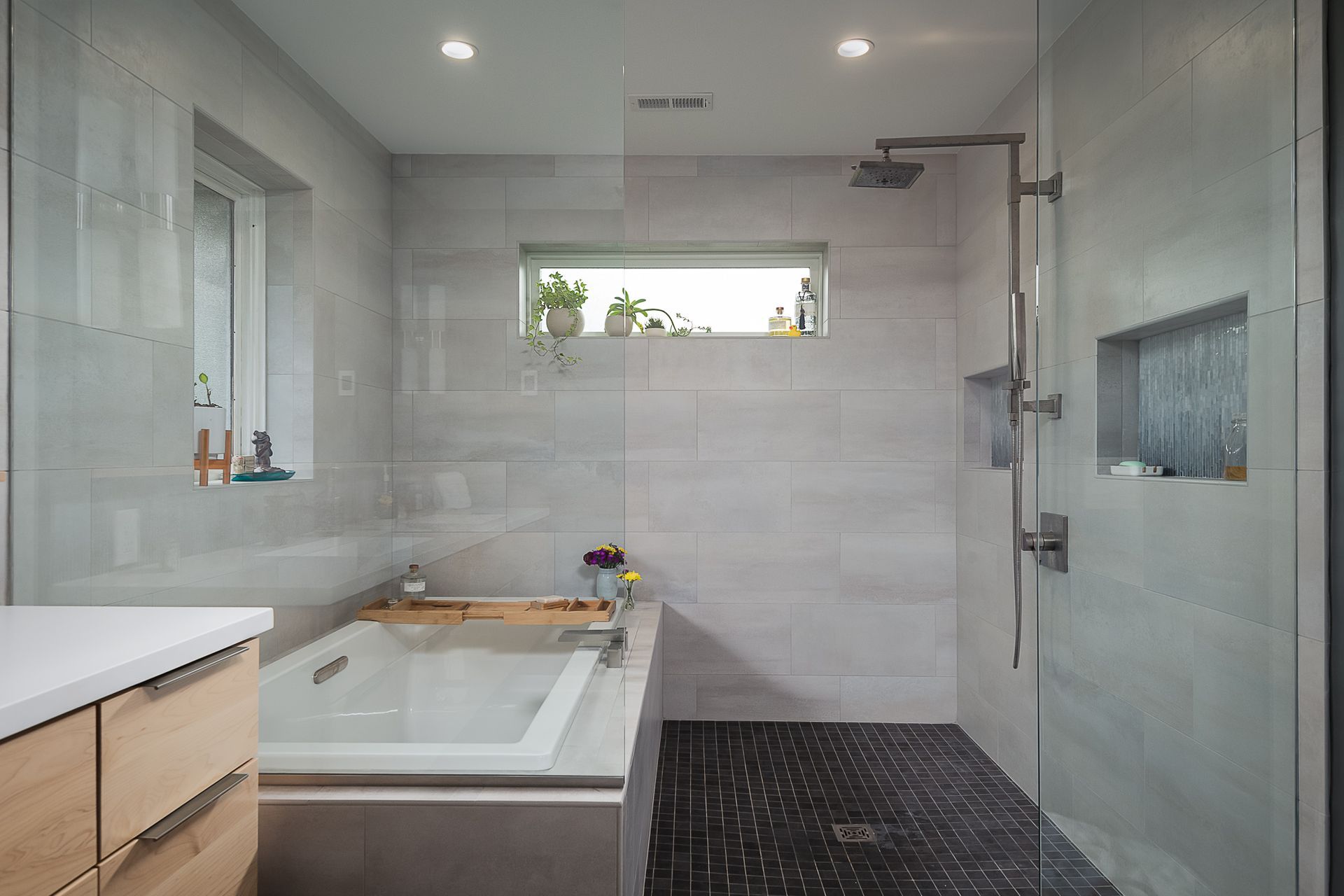 A bathroom with a tub and a walk in shower.