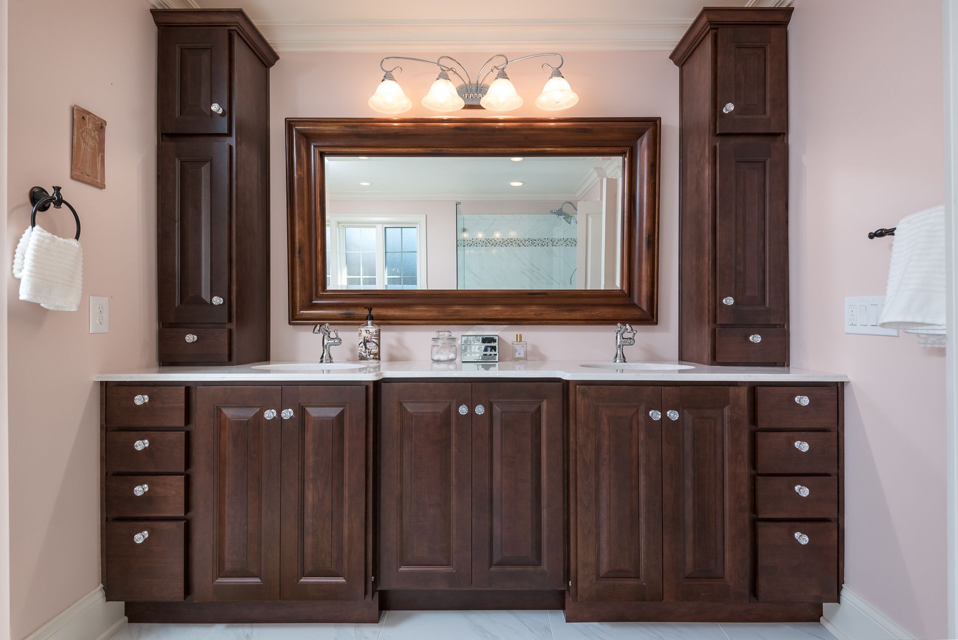 A bathroom with two sinks and a large mirror