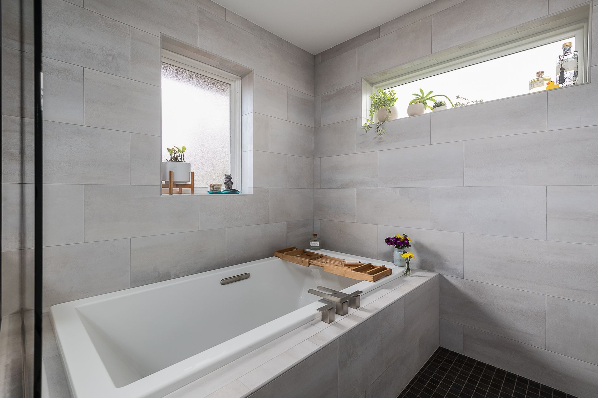 A bathroom with a bathtub and a window.