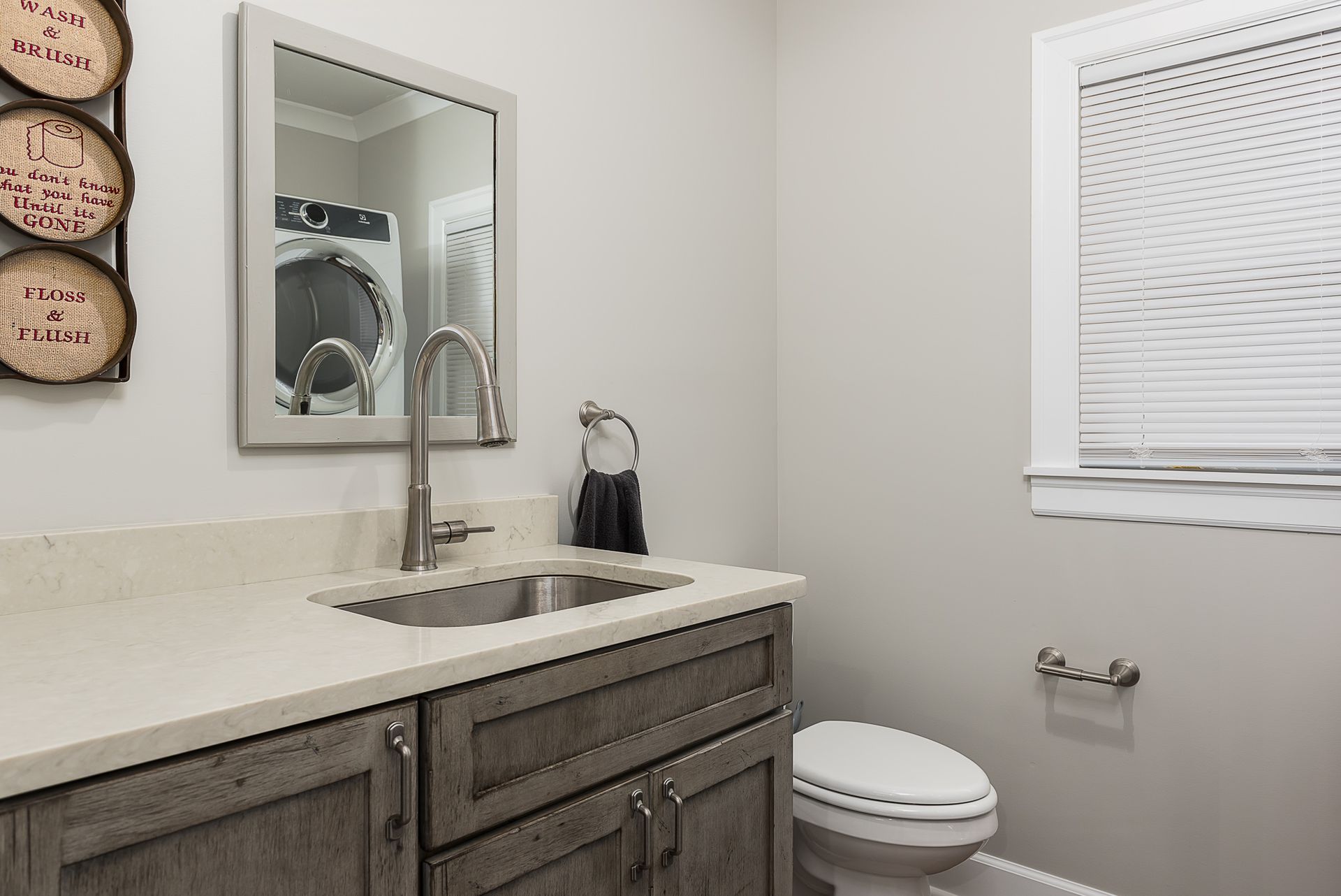 A bathroom with a sink , toilet and mirror.