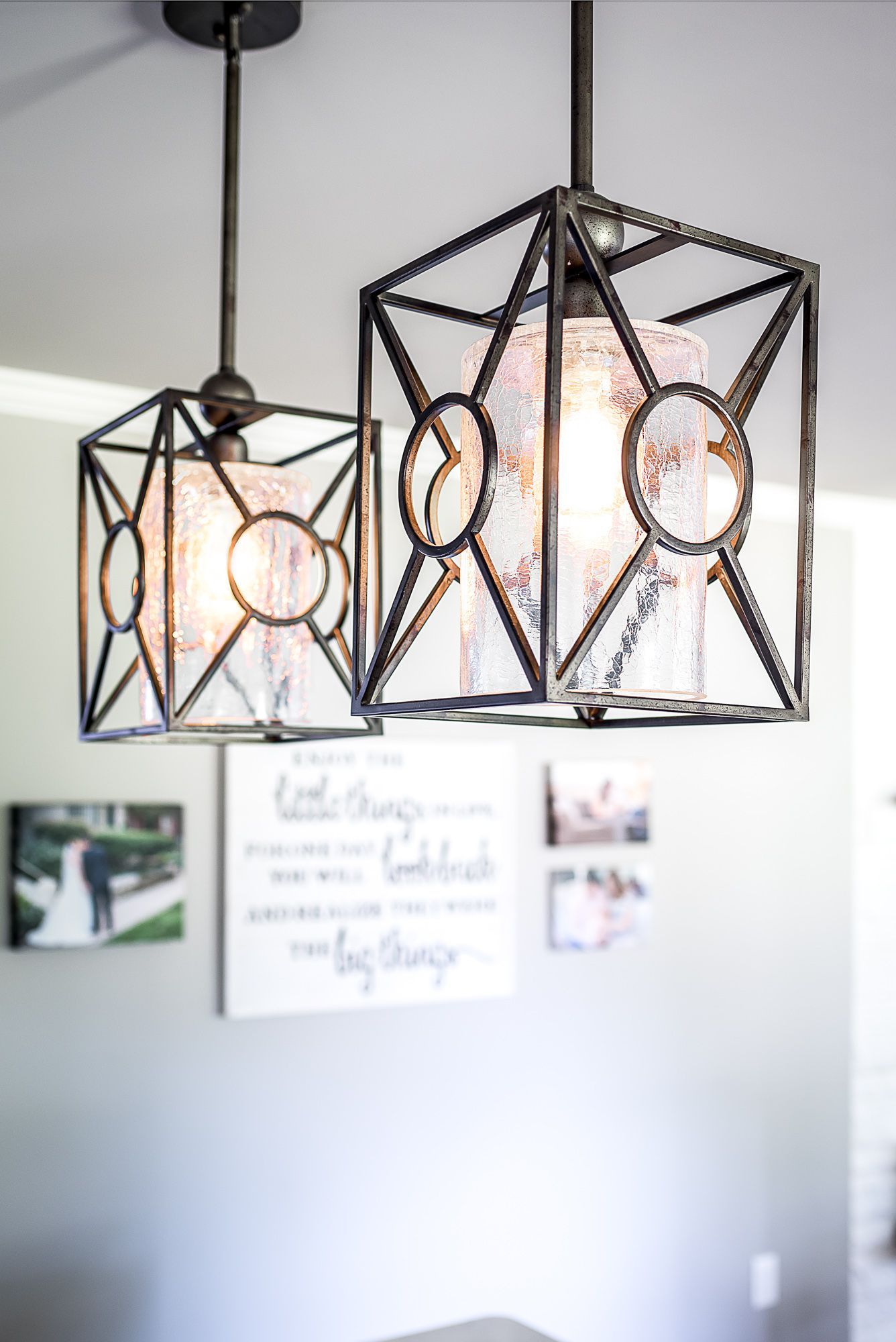 A couple of lights hanging from the ceiling in a room.