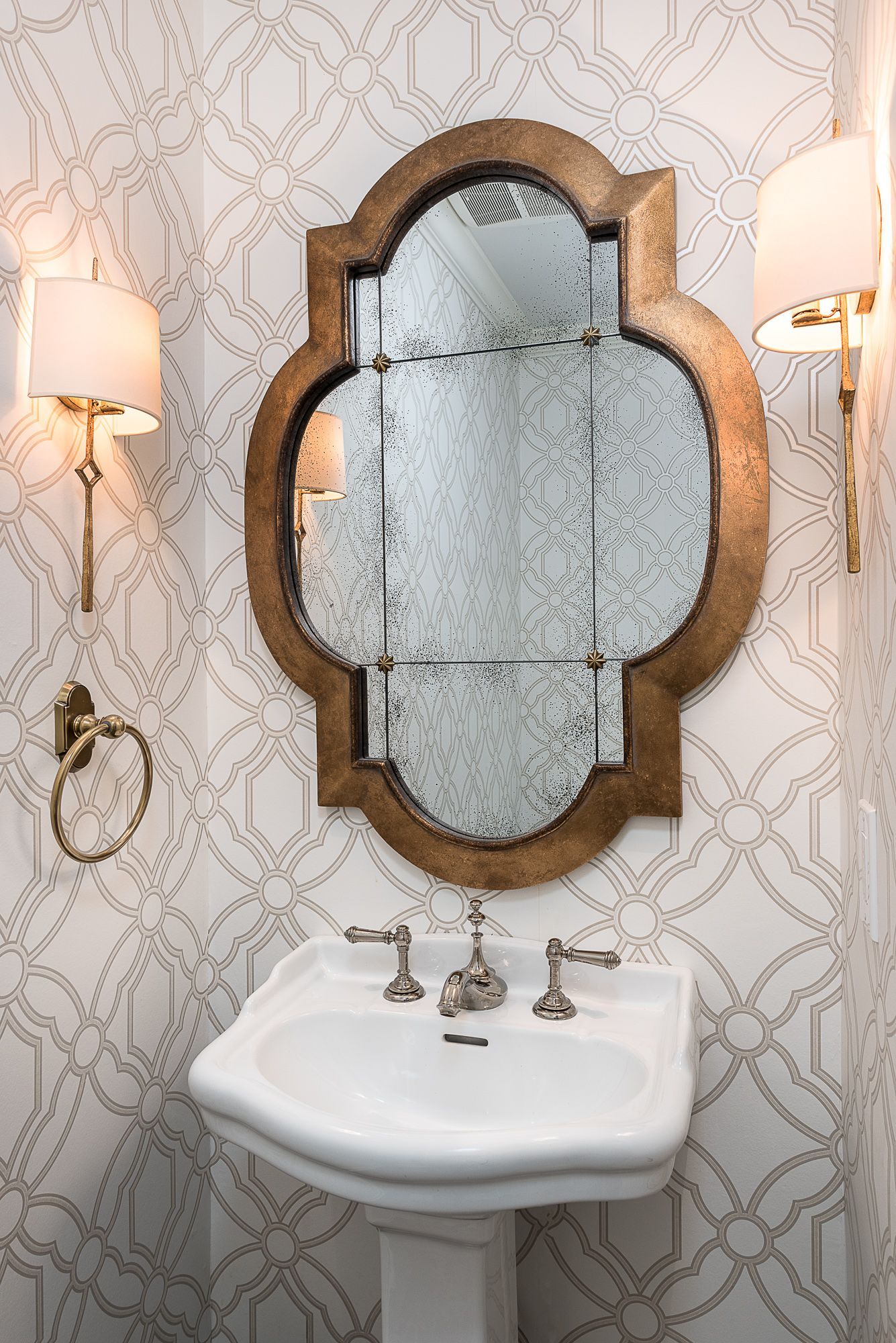 A bathroom with a sink and a mirror on the wall.