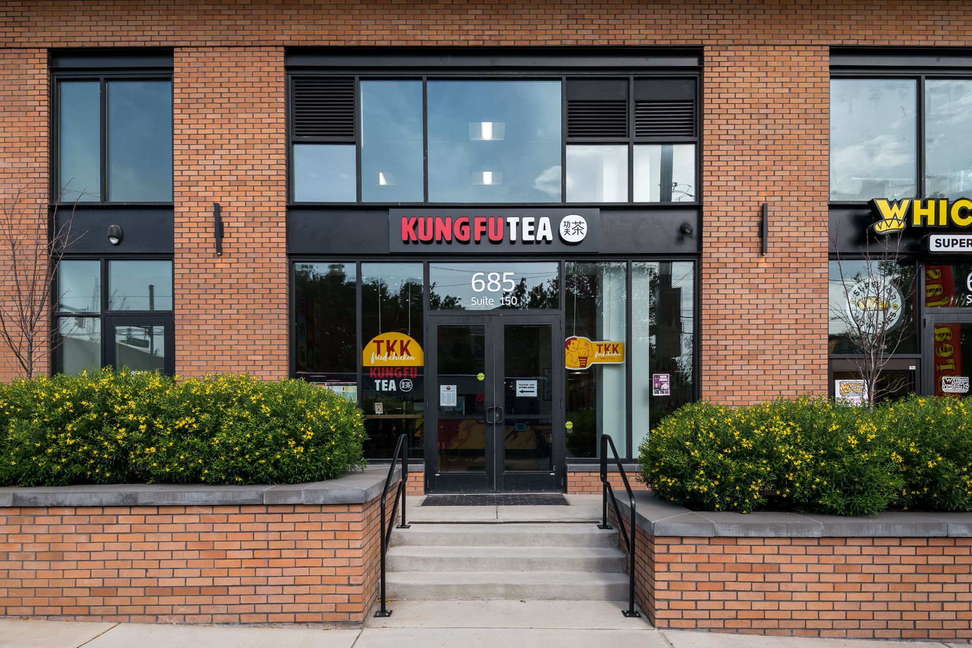 A brick building with a sign that says Kung Fu Tea