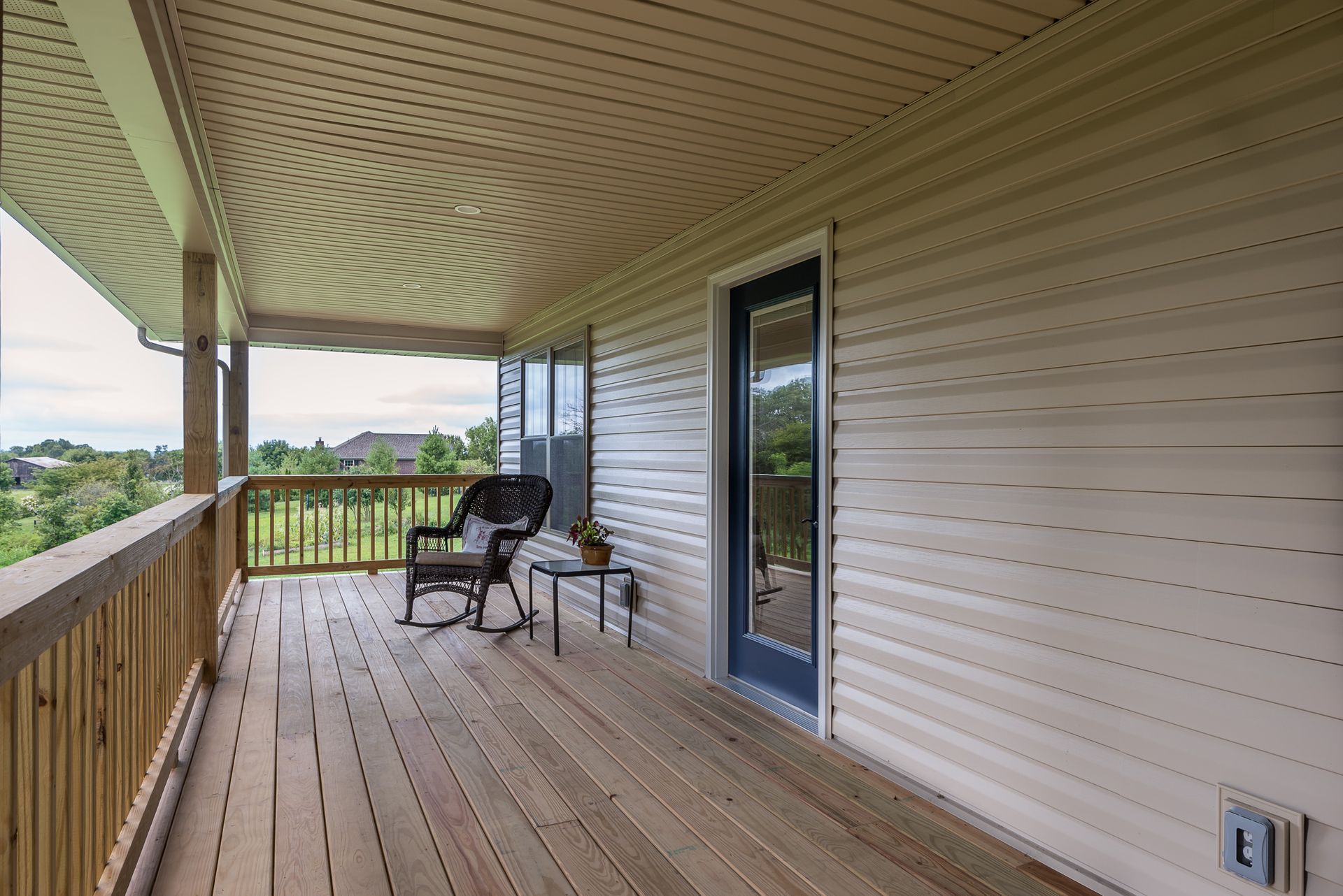 There is a rocking chair on the porch of a house.