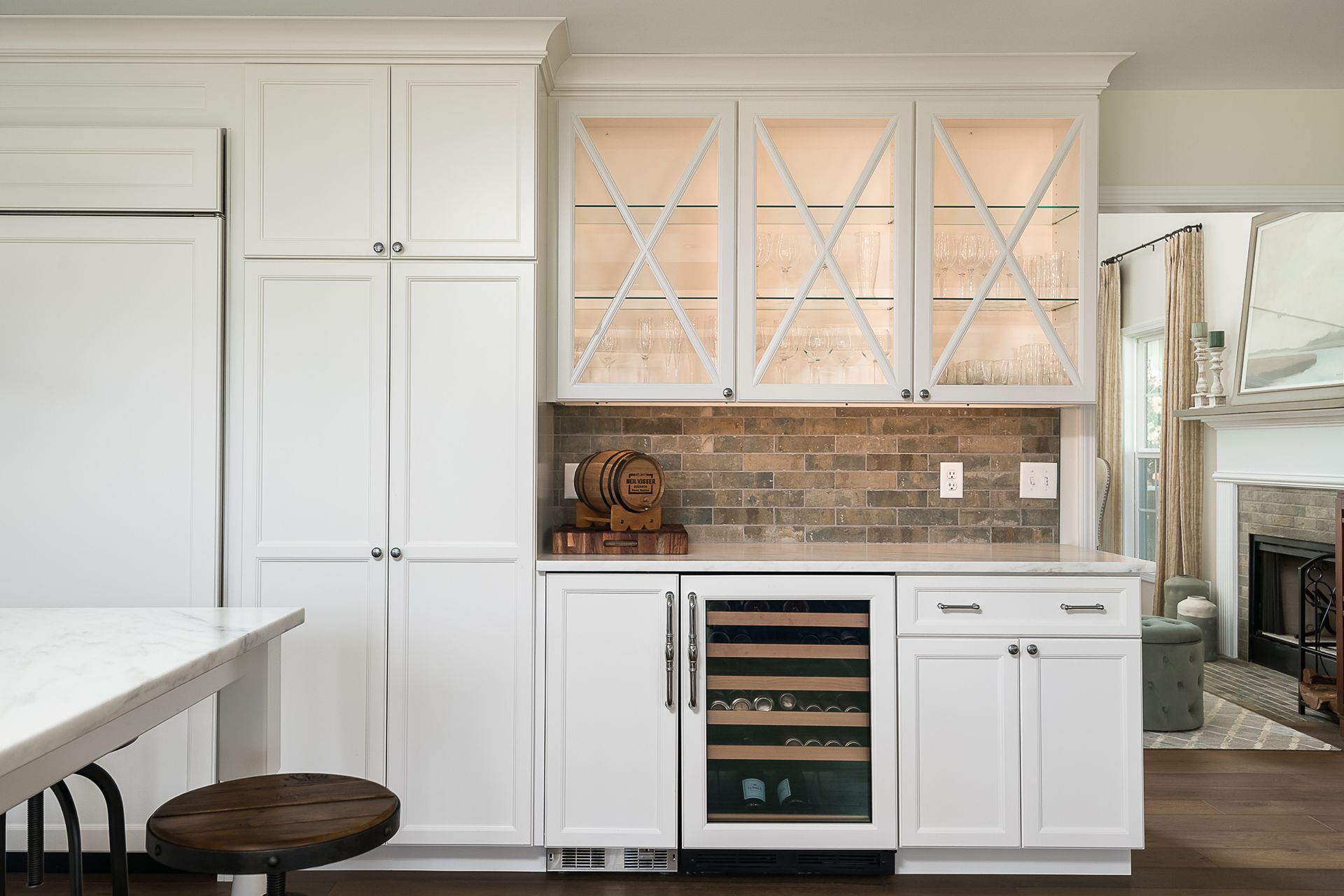 A kitchen with white cabinets and a wine cooler.