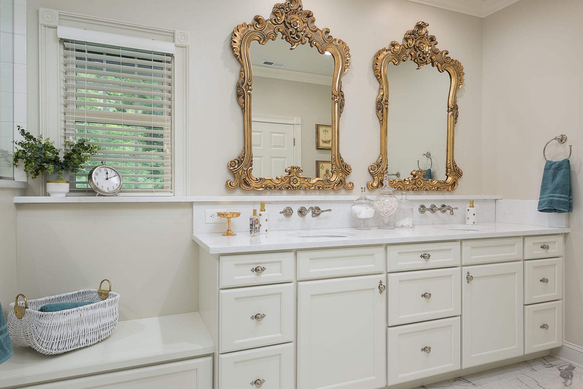 A bathroom with two sinks , two mirrors and a window.