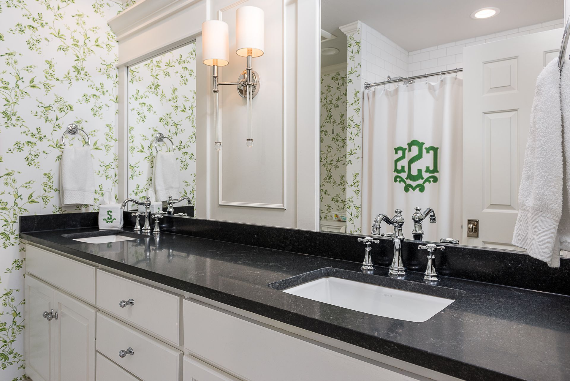 A bathroom with two sinks and a shower curtain with the number 221 on it