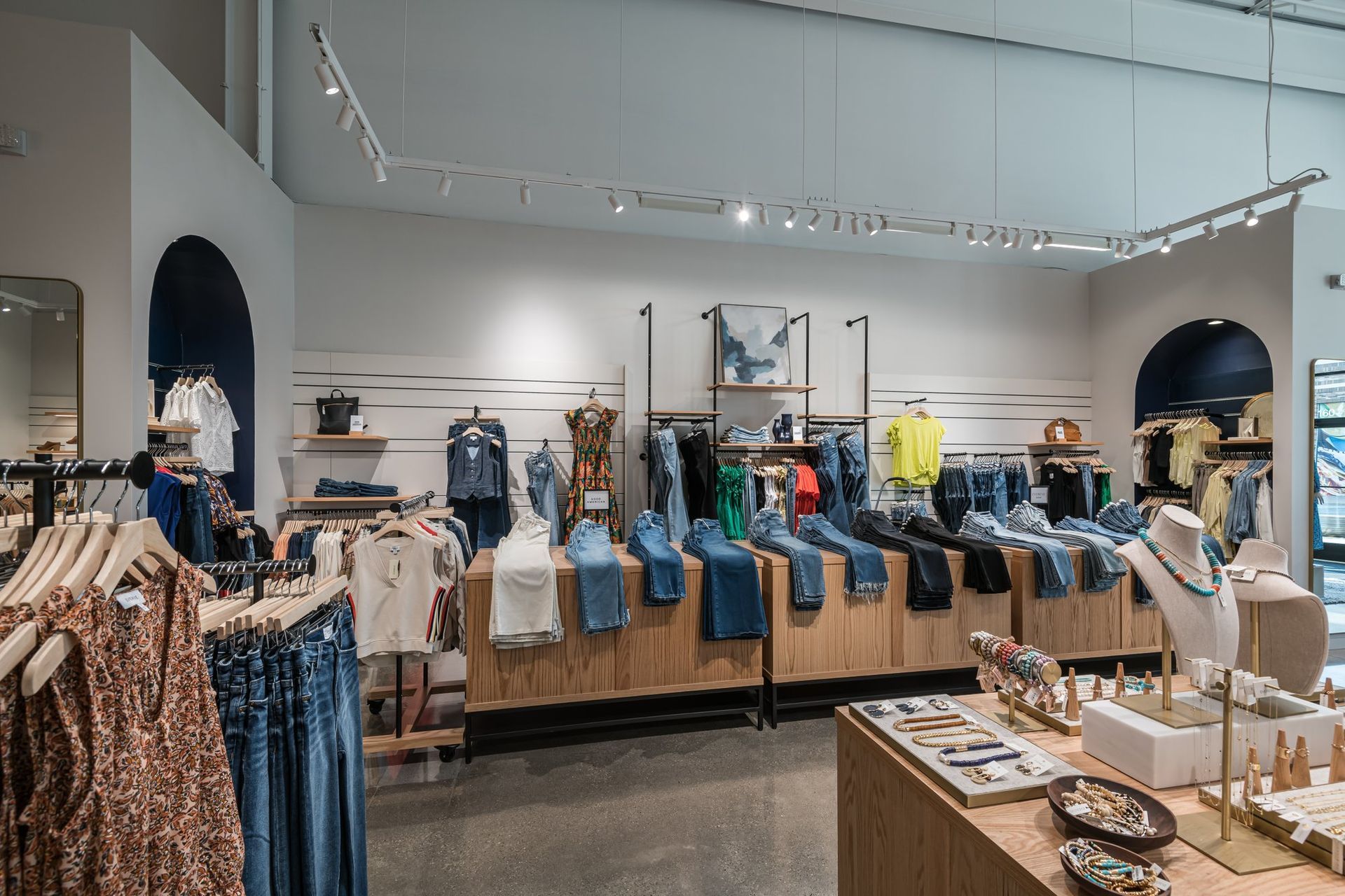 A clothing store filled with lots of clothes and jewelry.