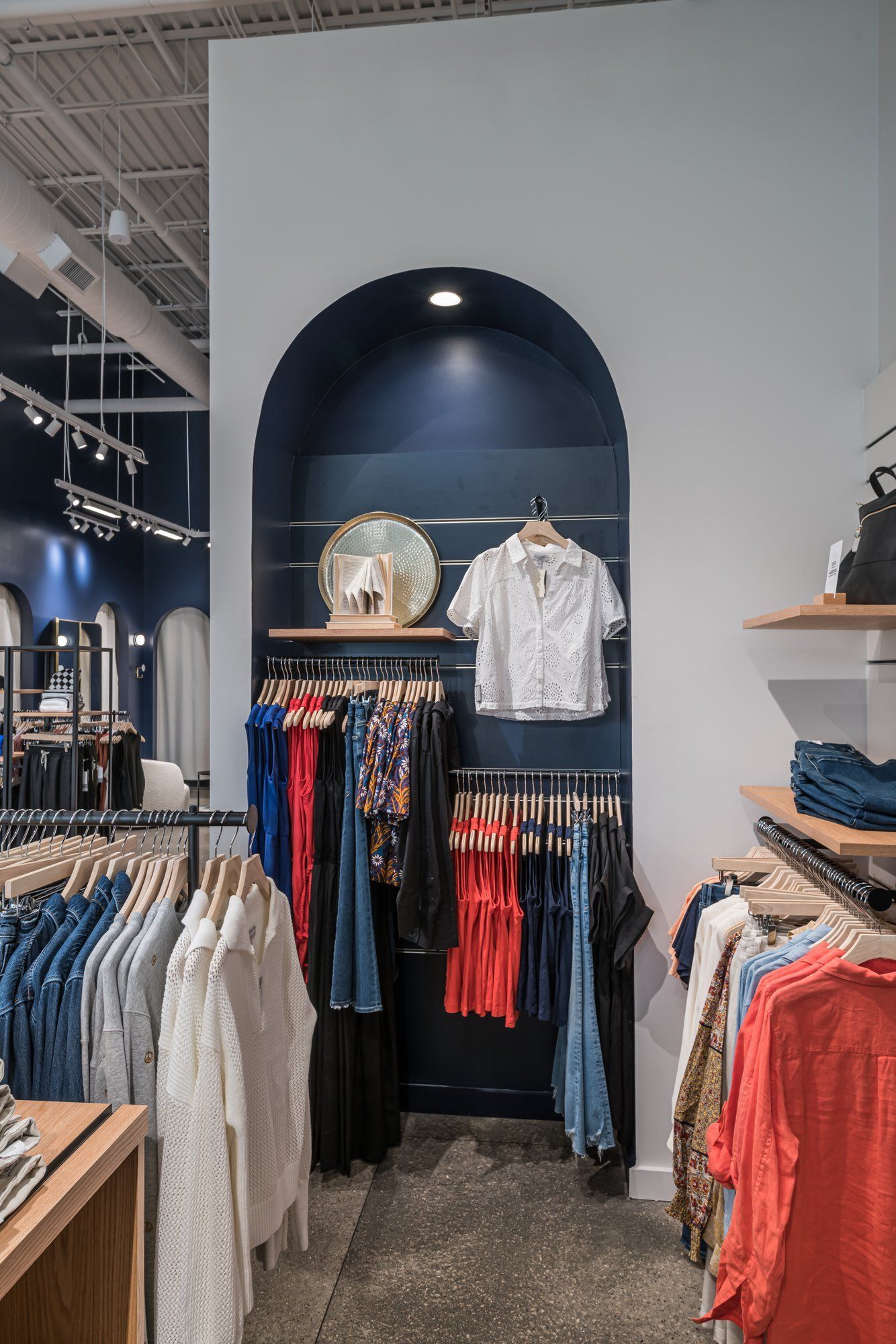 A store filled with lots of clothes hanging on racks.