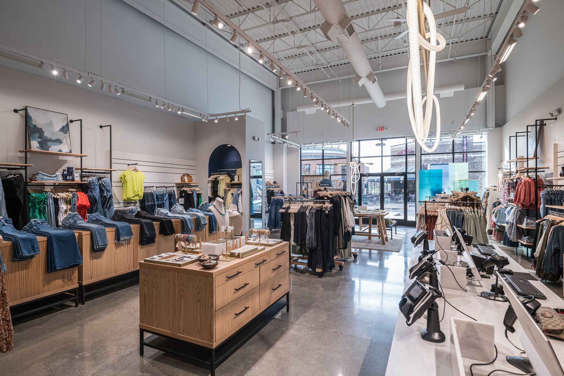 The inside of a clothing store with lots of clothes on display.