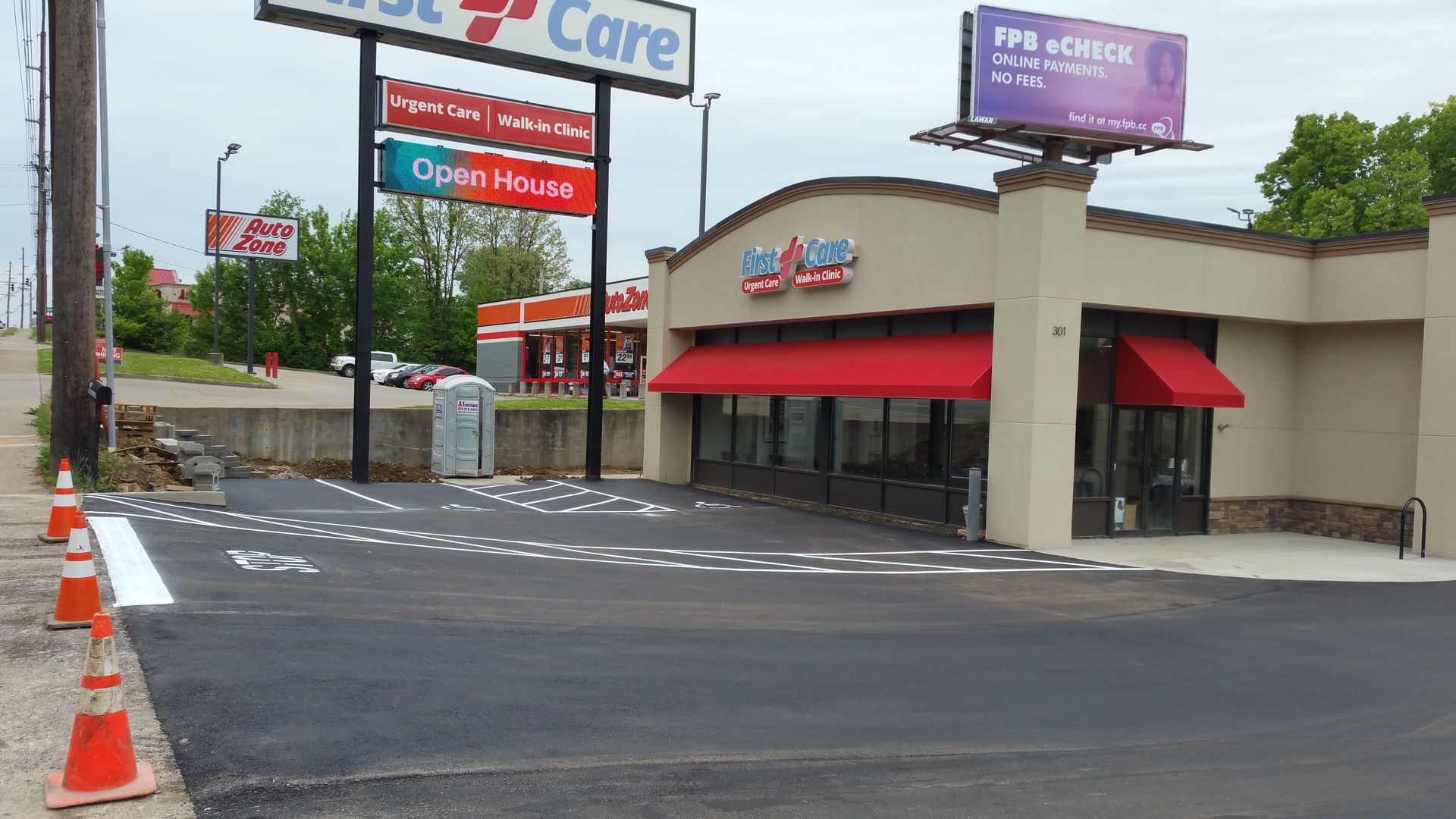A building with a red awning and a sign that says upper hand