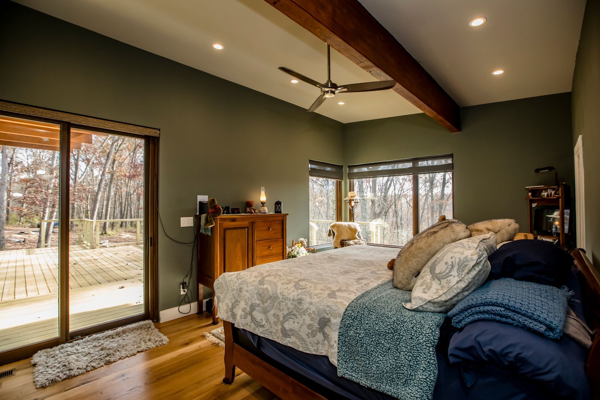 A bedroom with a large bed and a ceiling fan.