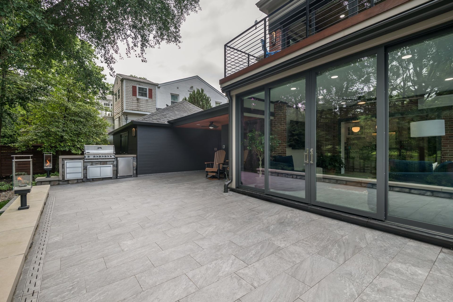 A large house with a lot of windows and a patio.