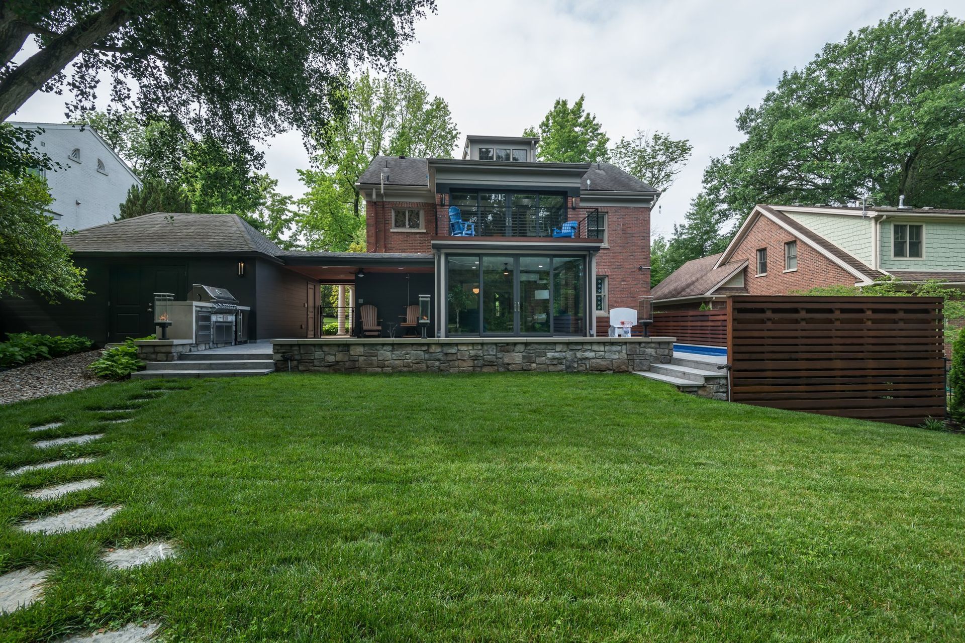 A large brick house with a large lawn in front of it