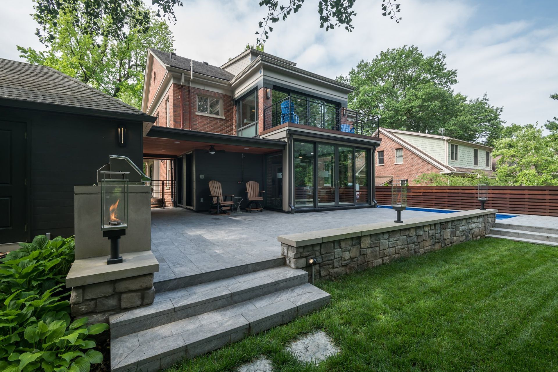 A large house with a patio and stairs in front of it