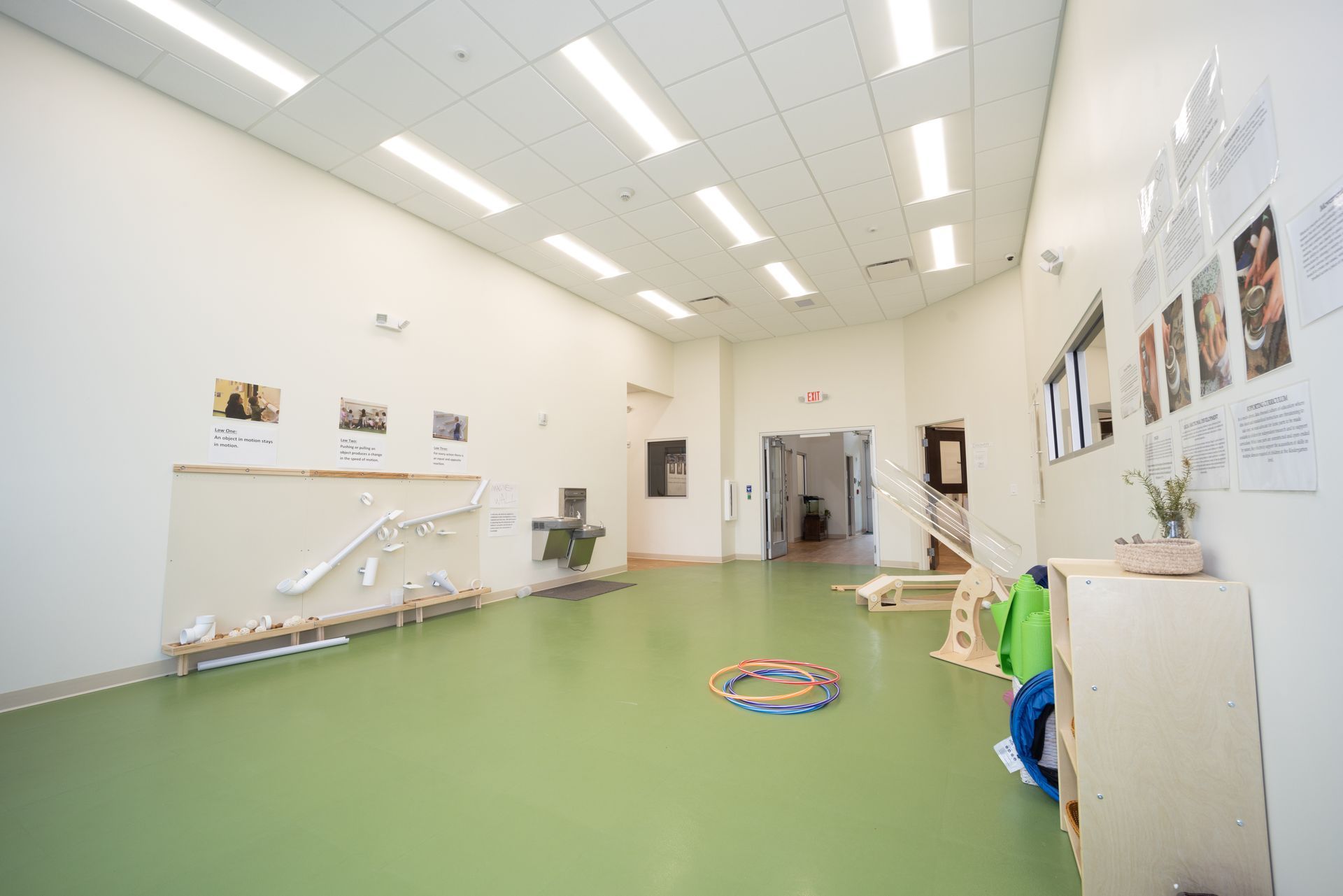 A large room with a green floor and white walls.