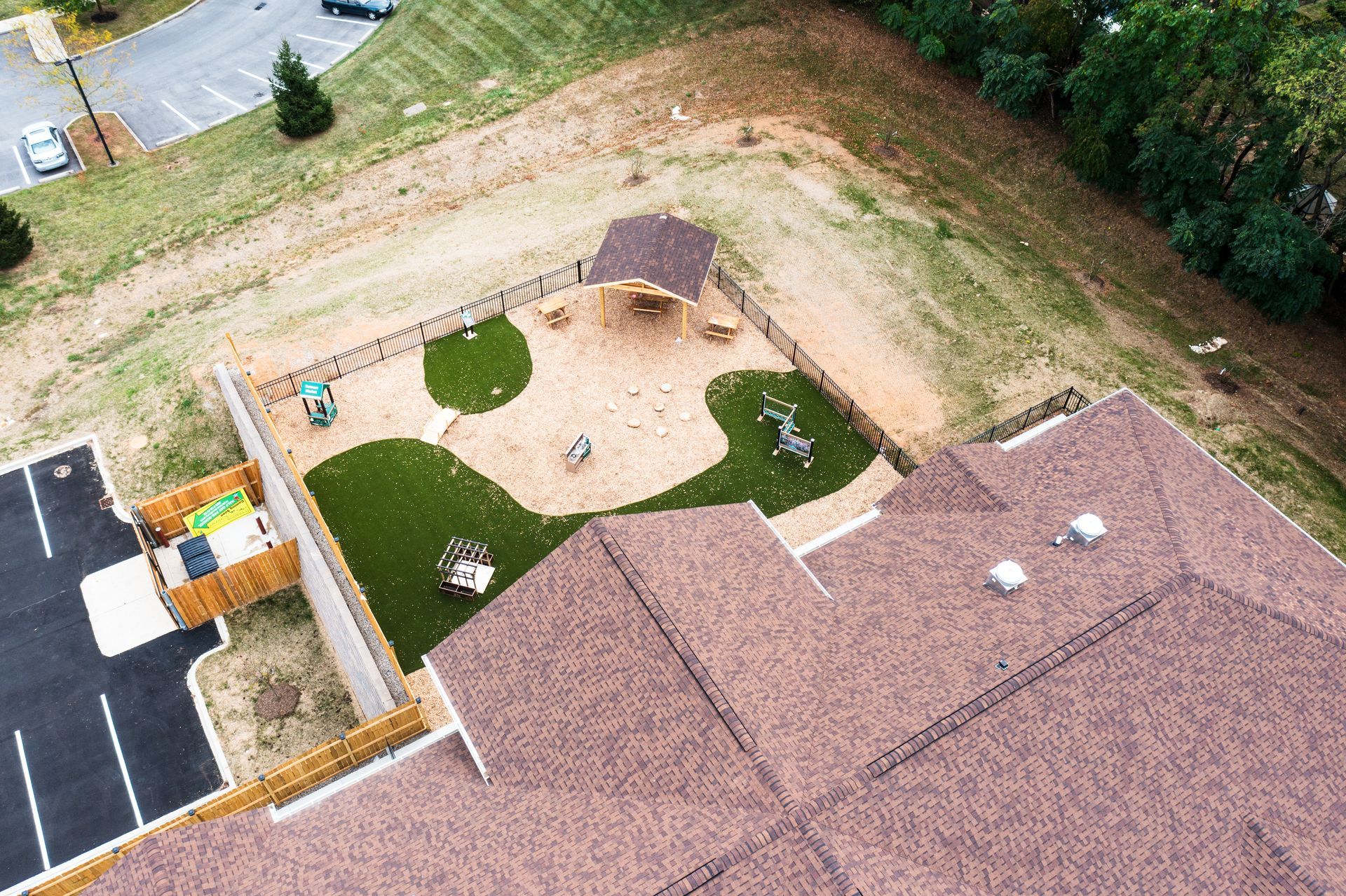 An aerial view of a house with a playground in front of it.