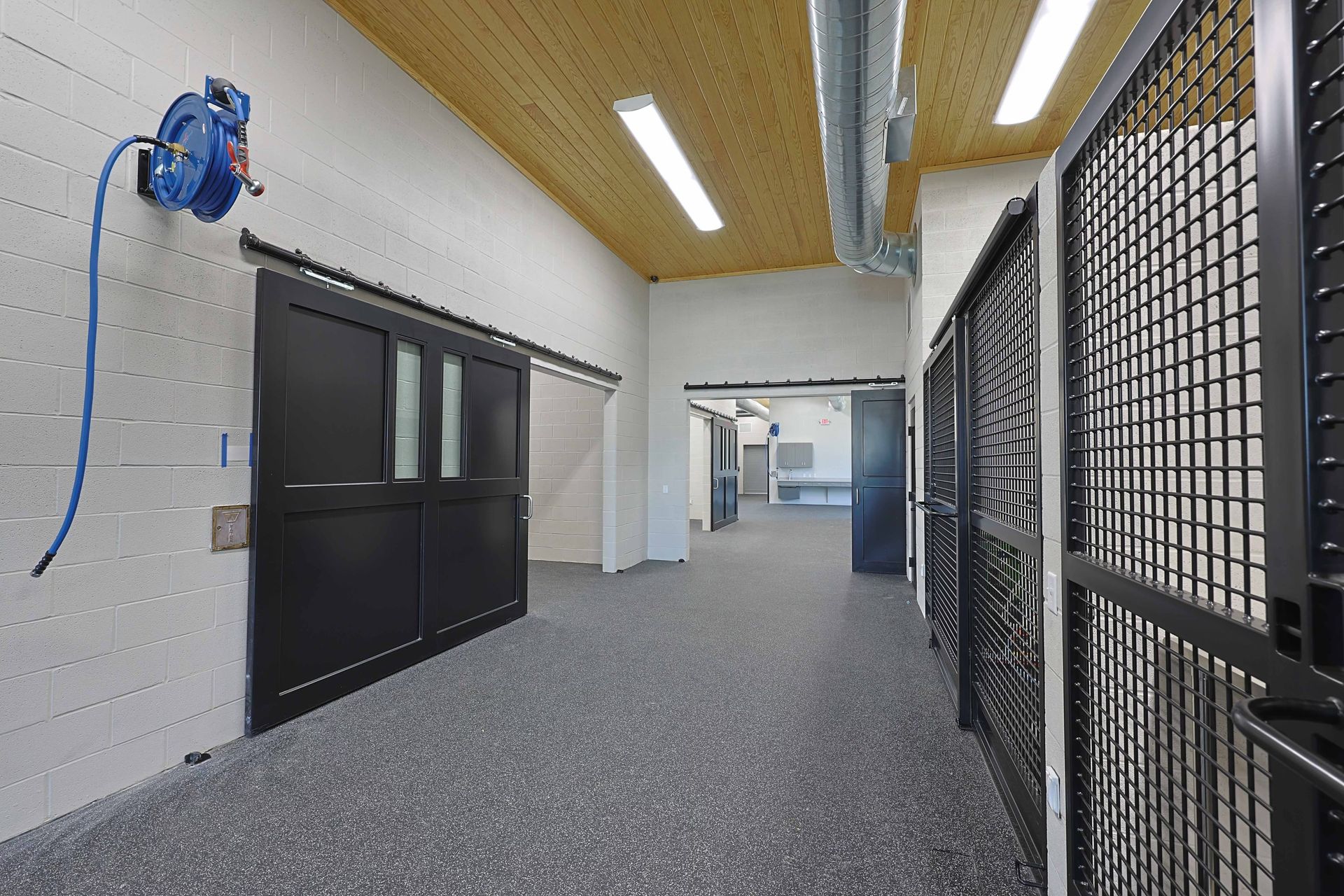 A long hallway with a hose attached to the wall